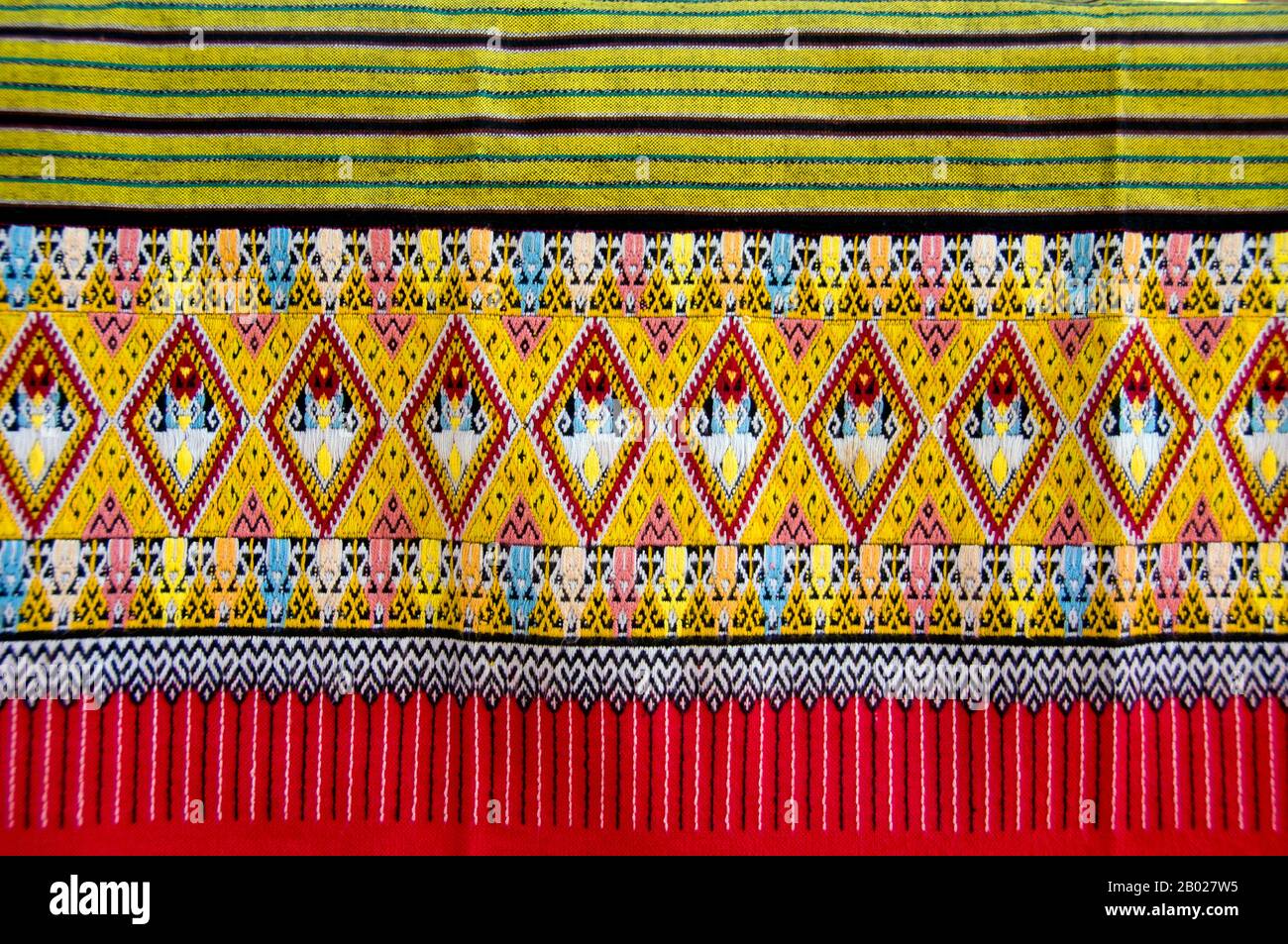 Women in and around Mae Chaem weave intricately-patterned hems called tin  chok (ตีนจก) for locally-produced phasin (ผ้าซิ่น) or tube dresses, usually  in the shadow of traditional wooden houses raised on stilts. These