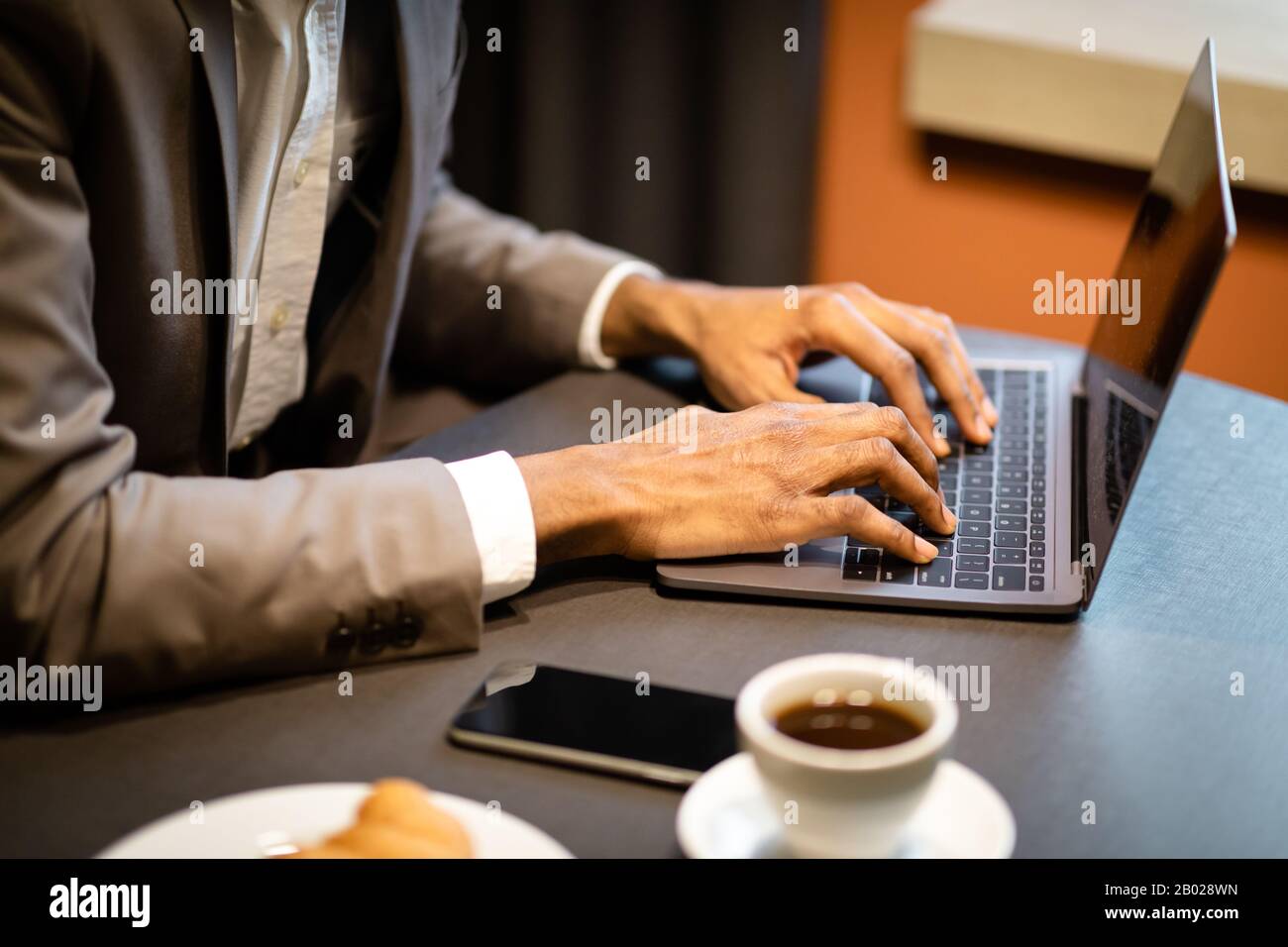 Cropped image of afro guy using laptop computer Stock Photo