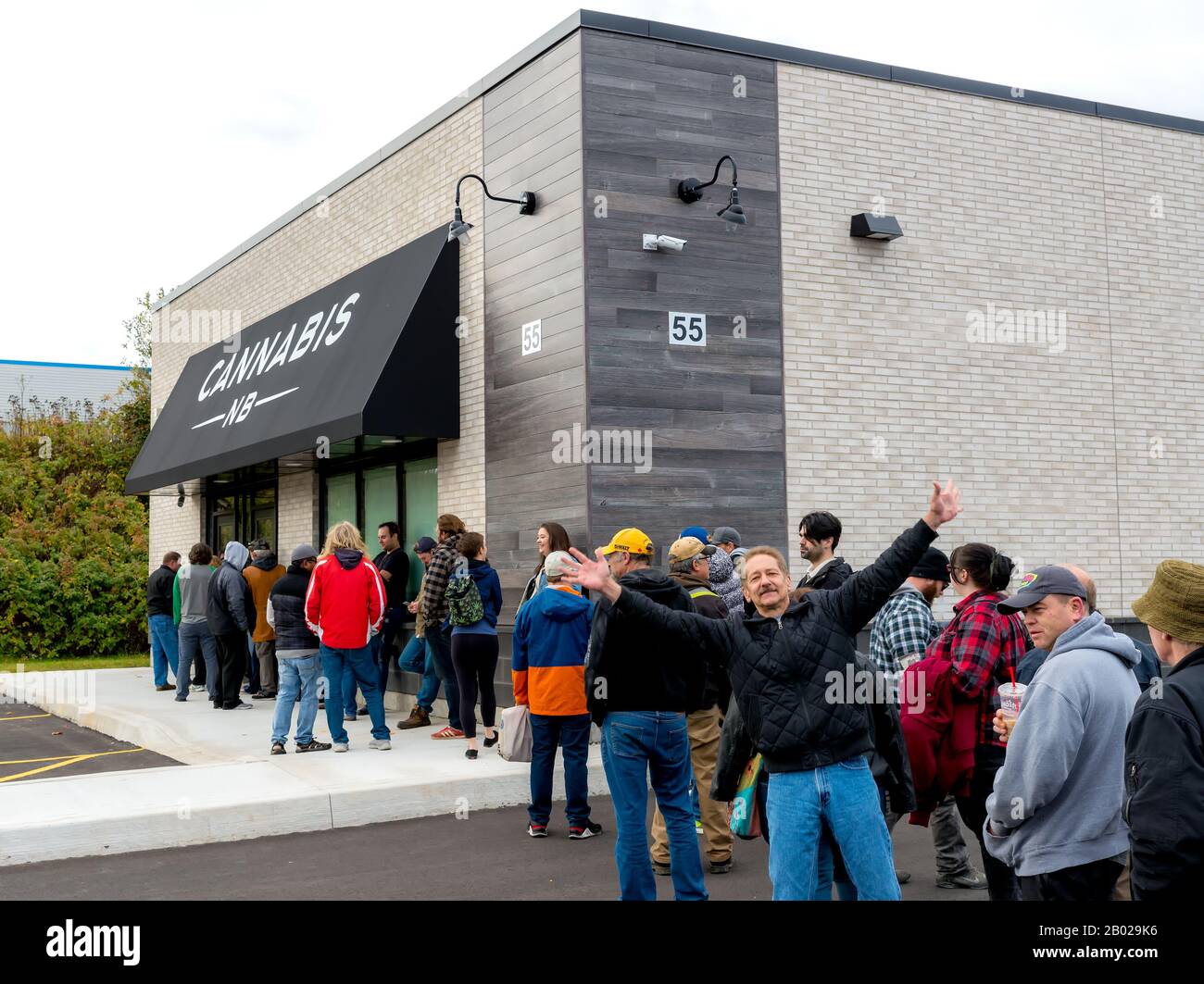 Saint John, New Brunswick, Canada - October 17, 2018: People line up to purchase cannabis legally from a Cannabis NB store. Stock Photo
