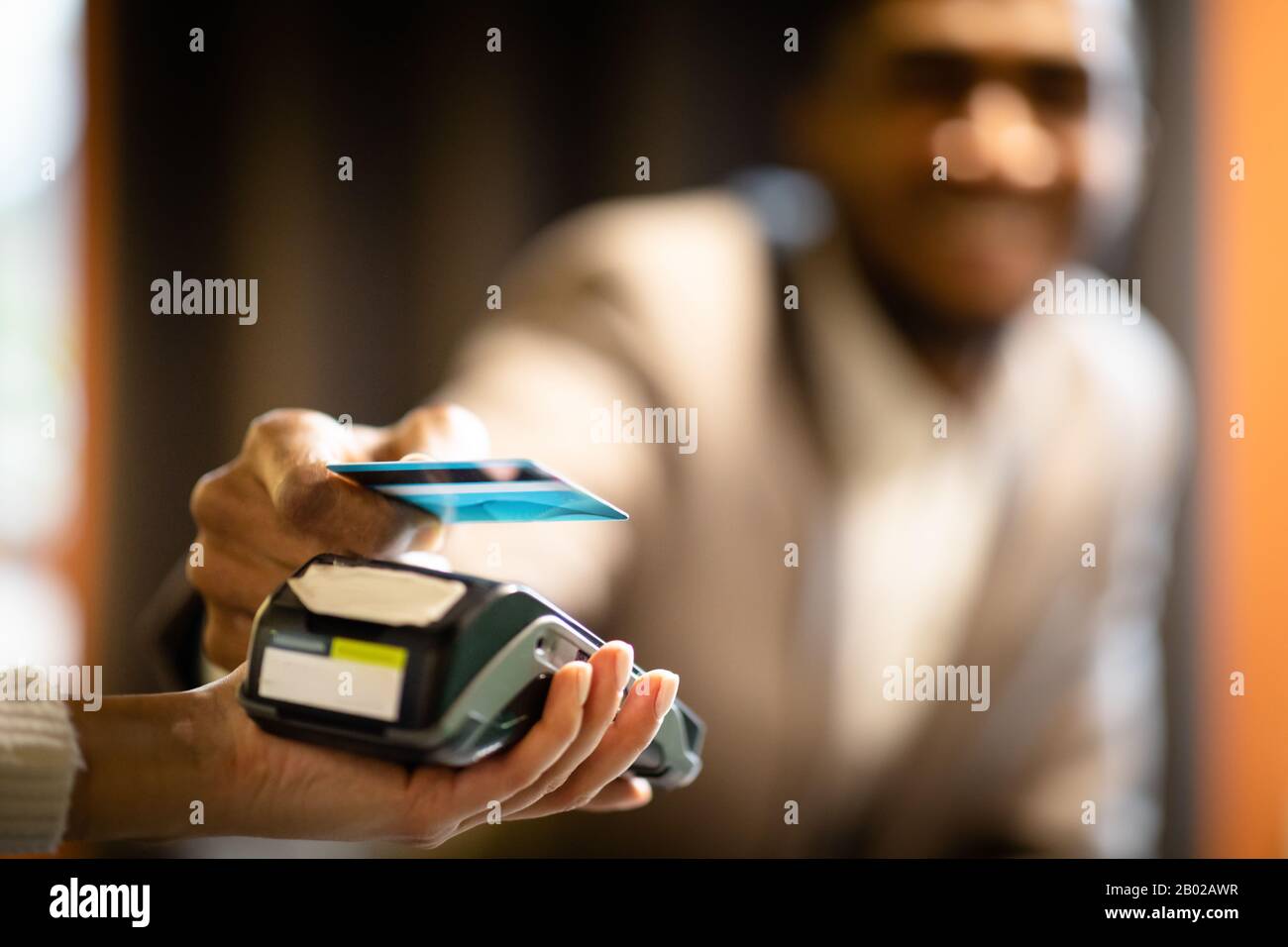 Afro businessman using modern contactless system at bar Stock Photo