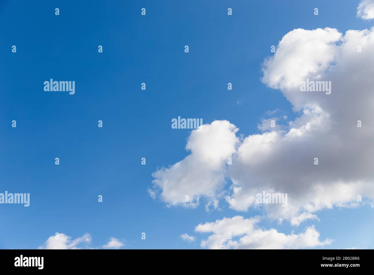 Scenic sky. Beautiful white soft fluffy clouds on a blue sky background Stock Photo