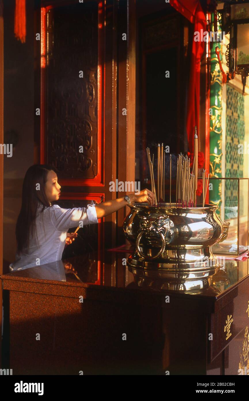 Guanyin is the bodhisattva associated with compassion as venerated by East Asian Buddhists, usually as a female. The name Guanyin is short for Guanshiyin which means 'Observing the Sounds (or Cries) of the World'. She is also sometimes referred to as Guanyin Pusa (simplified Chinese: 观音菩萨; traditional Chinese: 觀音菩薩; pinyin: Guānyīn Púsà; Wade–Giles: Kuan-yin Pu-sah; literally 'Bodhisattva Guanyin').  Some Buddhists believe that when one of their adherents departs from this world, they are placed by Guanyin in the heart of a lotus then sent home to the western pure land of Sukhāvatī.  It is gen Stock Photo