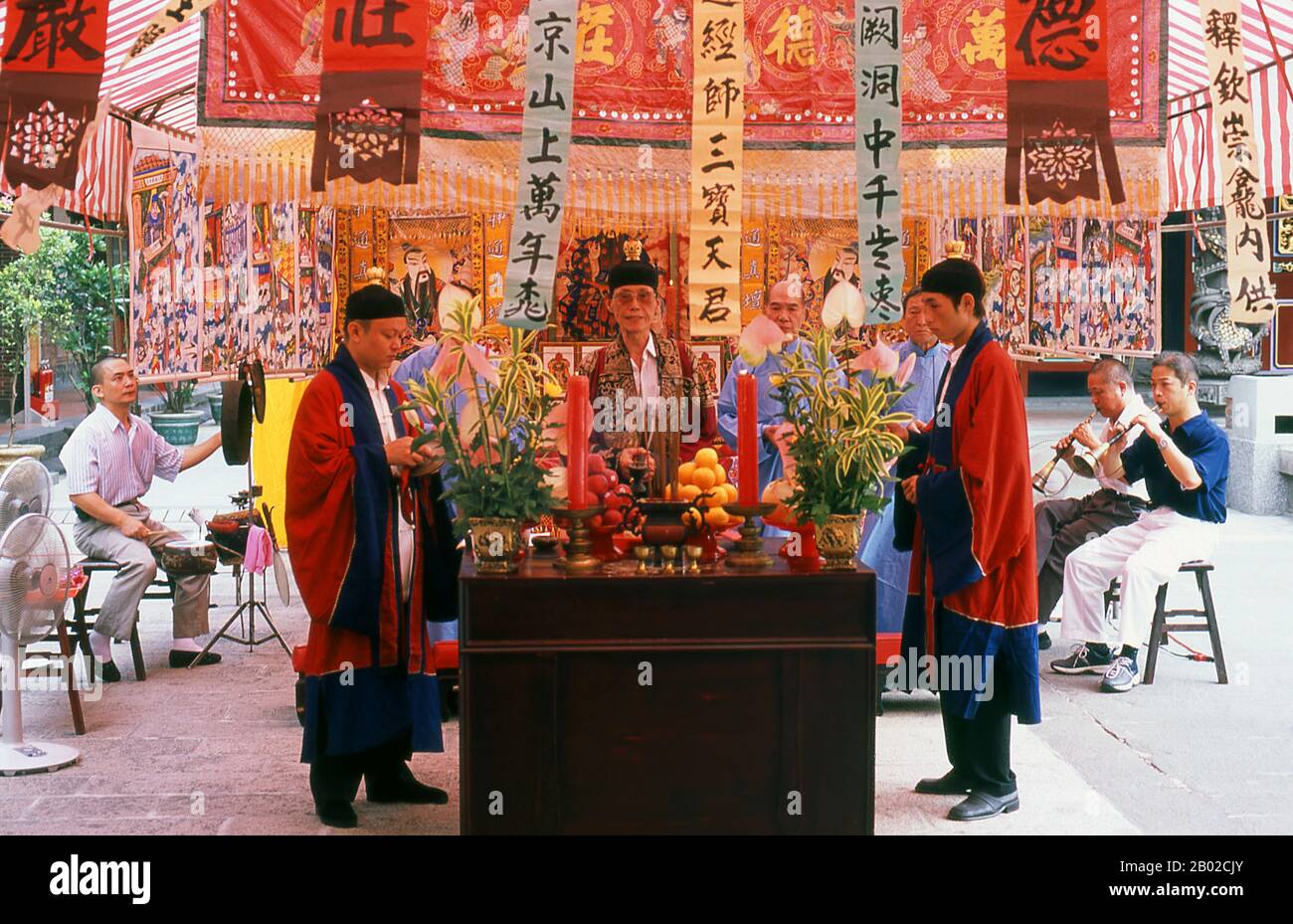 Taiwan: Taoist priests and traditional musical ensemble at Dalongdong Baoan Temple, Taipei.  Dalongdong Baoan Temple, also known as the Taipei Baoan Temple, is a Taiwanese folk religion temple built in the Datong district of Taipei, Taiwan.  The present temple was originally built by clan members in the Tong'an District who immigrated to Taipei in the early 19th century and gave the temple the name Bao'an in order to 'protect those of tong'an'.  The temple construction commenced in 1804 and replaced a previously existing wooden shrine from 1742 in Dalongdong. Stock Photo