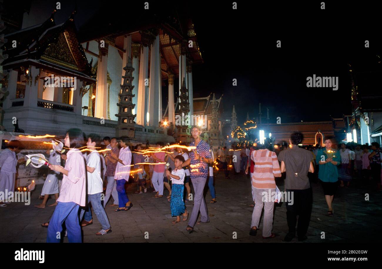 Beginning on the 15th day of the sixth lunar month, the Visakha Puja festival celebrates the Buddha’s birth, enlightenment and passing away, and is marked at Buddhist temples by chanting and preaching, and candlelit processions in the evening.  Wat Suthat Thepphawararam is a royal temple of the first grade, one of six such temples in Thailand. Construction was begun by King Buddha Yodfa Chulaloke (Rama I) in 1807. Further construction and decorations were carried out by King Buddha Loetla Nabhalai (Rama II) who helped carve the wooden doors, but the temple was not completed until the reign of Stock Photo