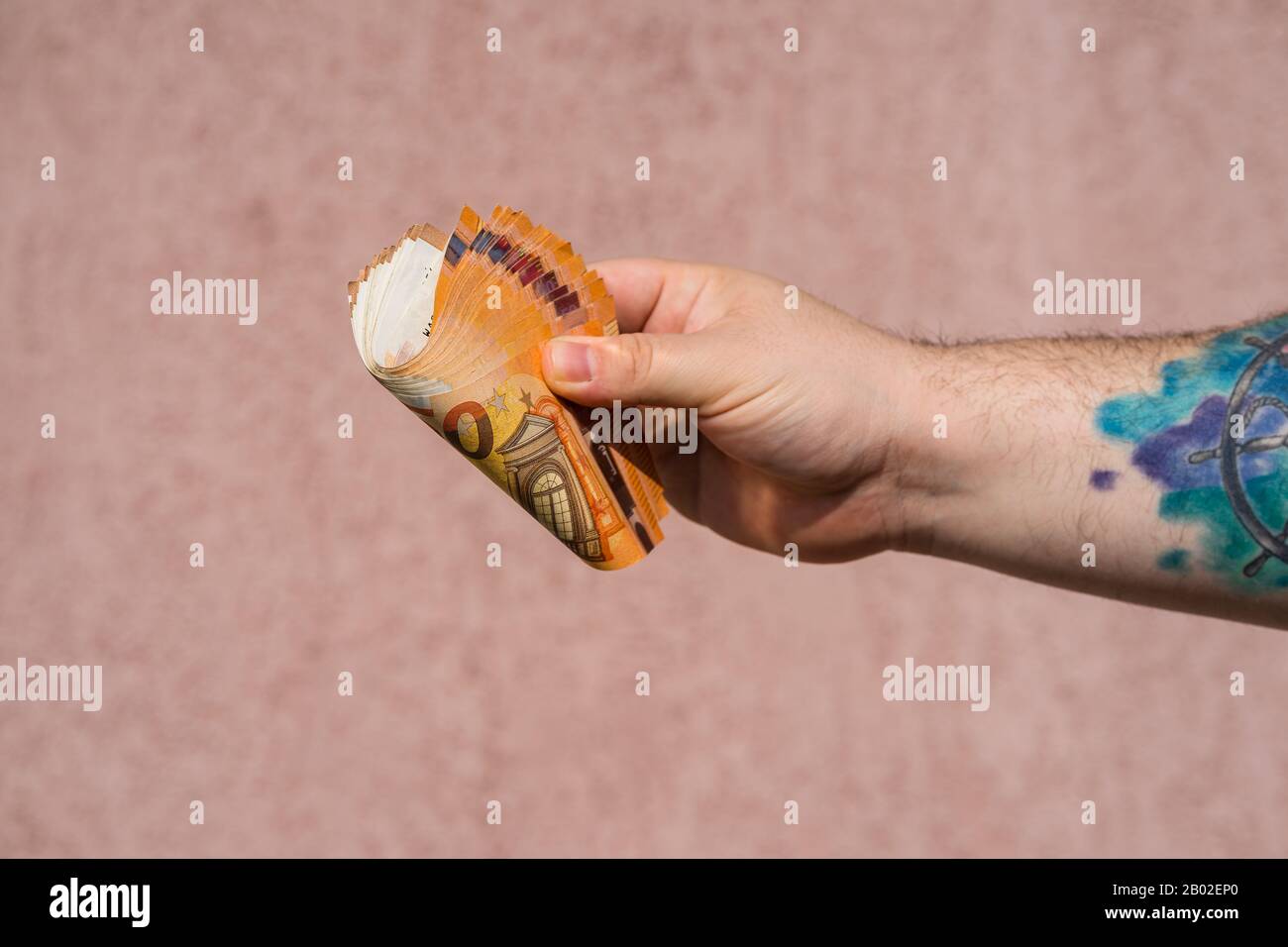 Tattooing money and currency concept on naked back Stock Photo by  ©ra2studio 297179822