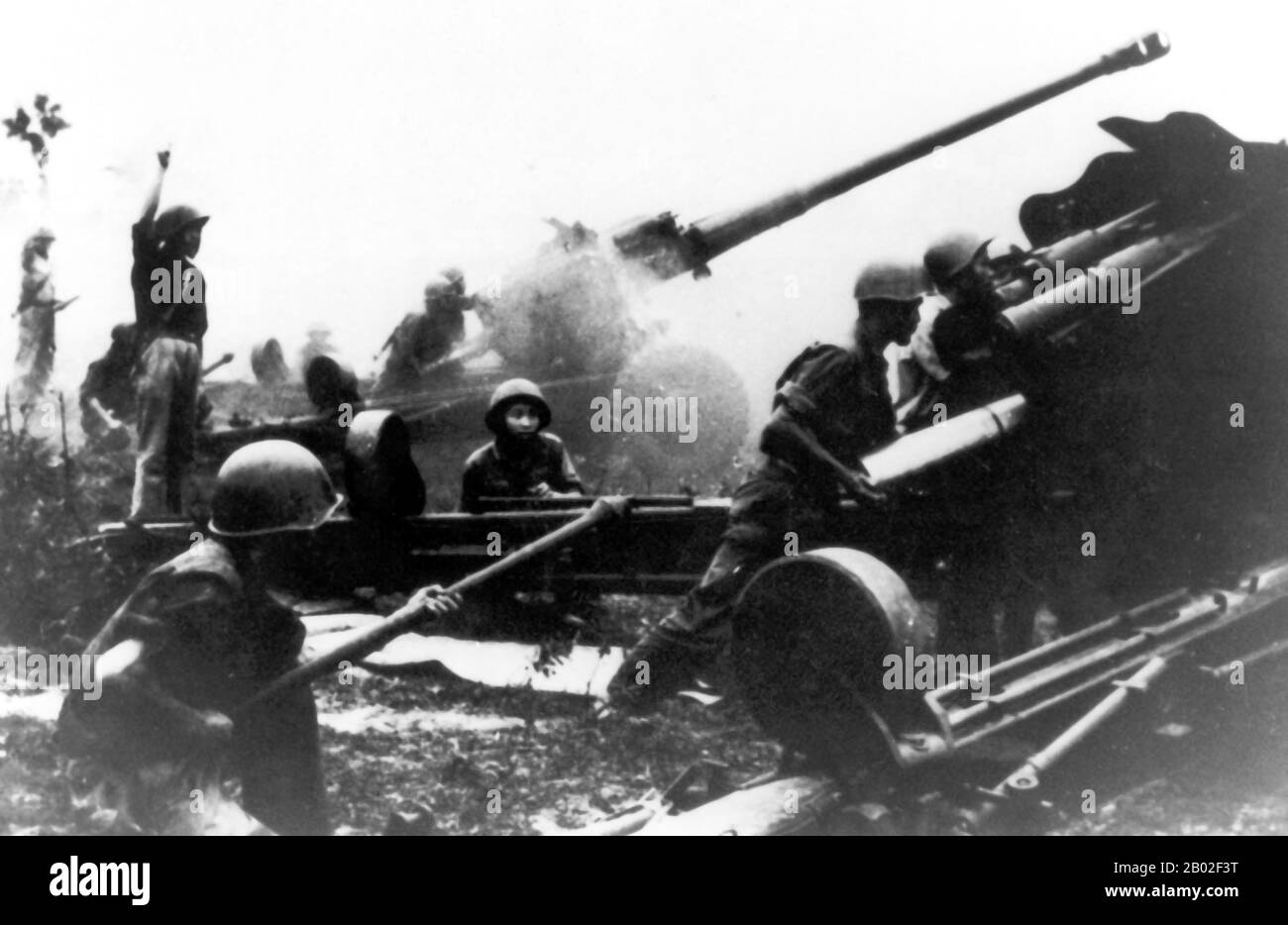 NVA Artillerymen fire their newly acquired Russian M46 (or Type 59 if built China) 130mm guns.  These guns were capable of providing deadly support for attacking infantry to a range of 27,000 meters, outranging the US 155mm and 8 inch  howitzers. Stock Photo