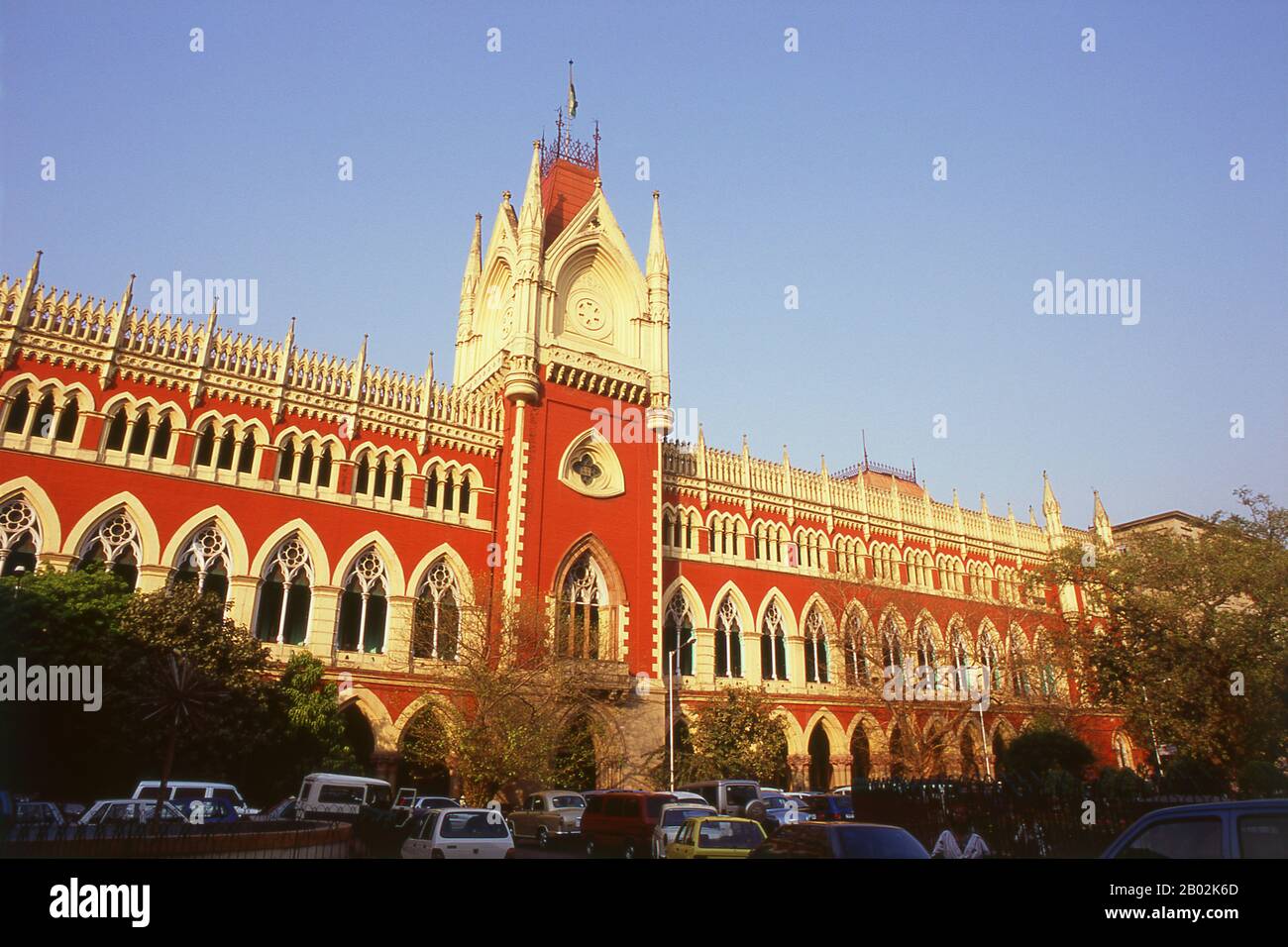 The Calcutta High Court (it retains the old name as it is an institution) was built in a neo-Gothic style in 1872, by the architect Walter Granville.  The tax records of Mughal Emperor Akbar (1584–1598) as well as the work of a 15th century Bengali poet, Bipradaas, both mention a settlement named Kalikata (thought to mean ‘Steps of Kali’ for the Hindu goddess Kali) from which the name Calcutta is believed to derive.  In 1690 Job Charnock, an agent of the East India Company, founded the first modern settlement in this location. In 1698 the company purchased the three villages of Sutanuti, Kolik Stock Photo