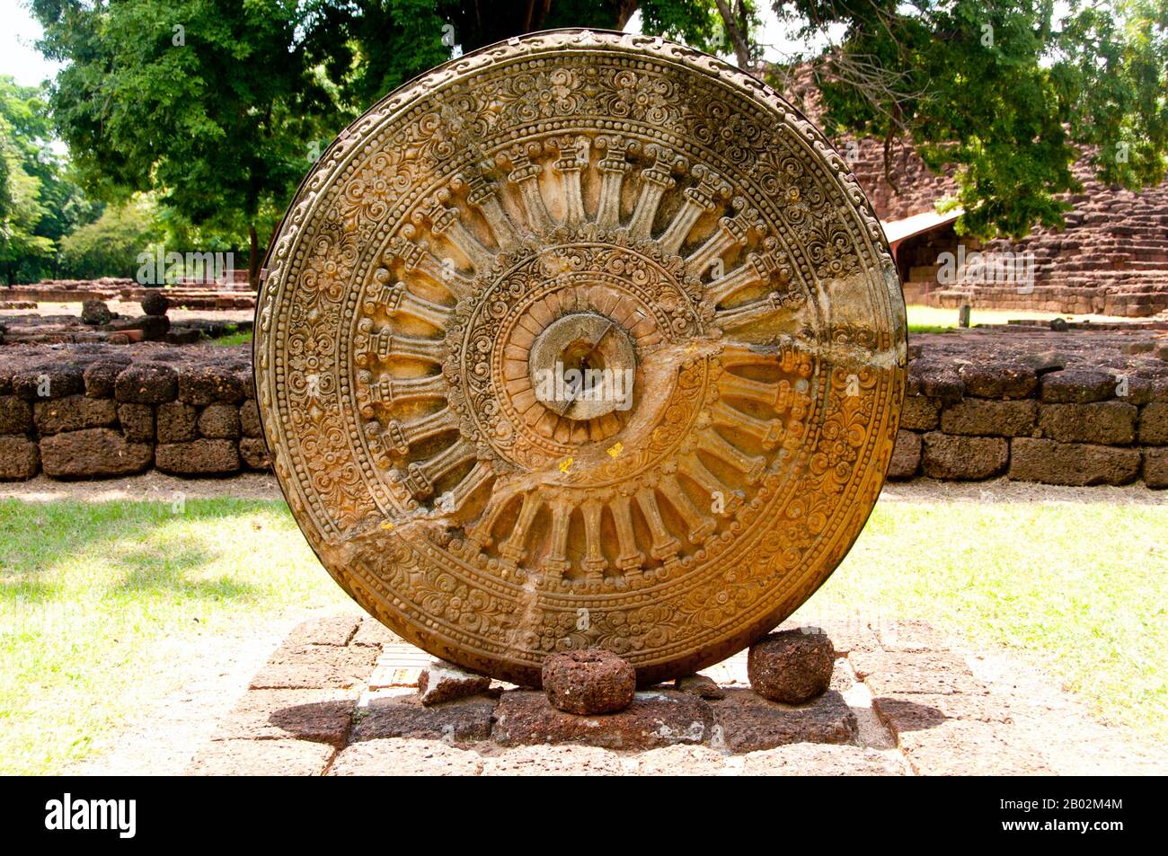 The Dharmachakra (Sanskrit: धर्मचक्र; Pāli: Dhammacakka; Tibetan: འཀོར་ལོ། (chos kyi 'khor lo); Chinese: 法輪; pinyin: fălún), lit. 'Wheel of Dharma' or 'Wheel of Law' is a symbol that has represented dharma, the Buddha's teaching of the path to enlightenment, since the early period of Indian Buddhism. A similar symbol is also in use in Jainism. It is one of the Ashtamangala symbols. Si Thep, also Sri Thep, (7th – 14th century CE) is an ancient ruined town in Northeast Thailand. Many architectural structures still remain to indicate its past prosperity. It was once the centre of contact between Stock Photo