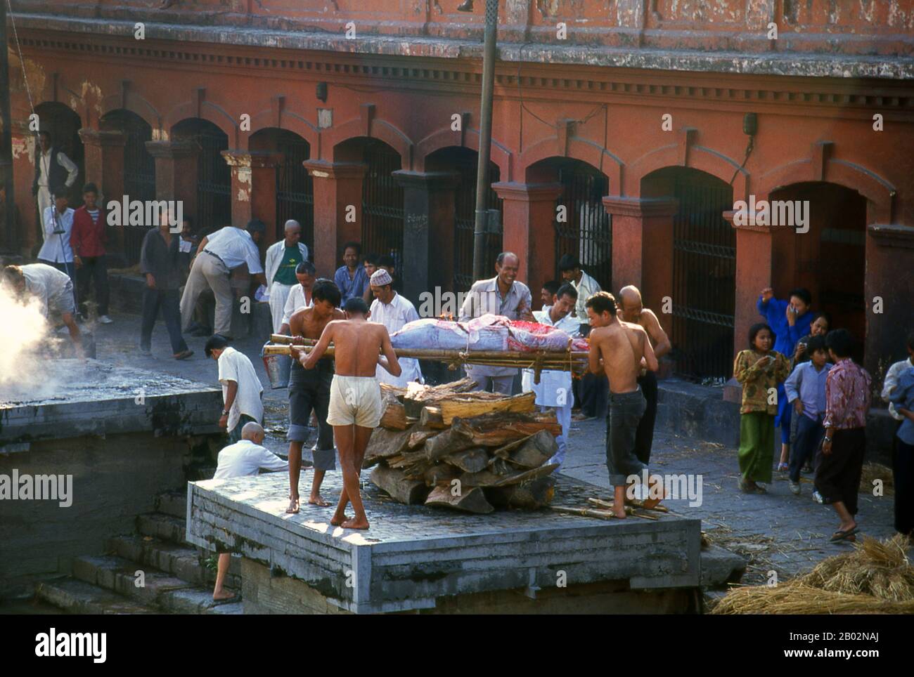 At Pashupatinath the cremation ghat (steps) are divided into two sections, Arya Ghat (Steps of the Nobles) and Surya Ghat (Steps of the Sun). The former is reserved for members of the higher castes, including members of the royal family, the latter for the common people.    The most revered Hindu site in Nepal is the extensive Pashupatinath Temple complex, five kilometres east of central Kathmandu. The focus of devotion here is a large silver Shivalingam with four faces of Shiva carved on its sides, making it a 'Chaturmukhi-Linga', or four-faced Shivalingam. Pashupati is one of Shiva’s 1,008 n Stock Photo
