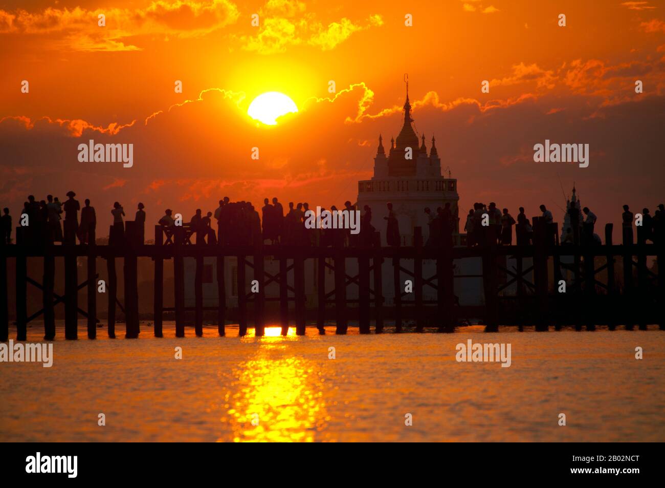Burma / Myanmar: People gather to watch the sunset on the U Bein Bridge ...