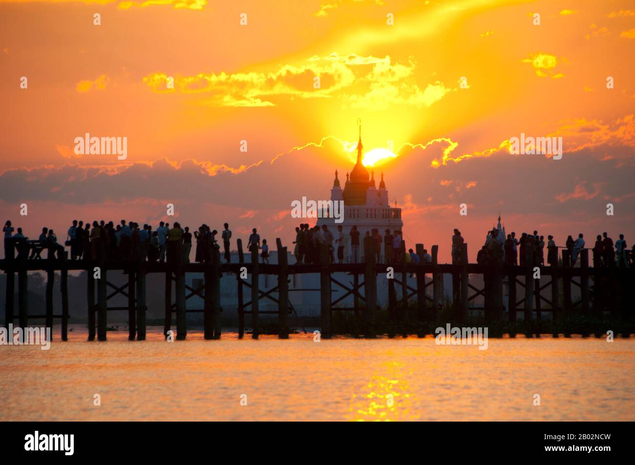 Burma / Myanmar: People gather to watch the sunset on the U Bein Bridge ...