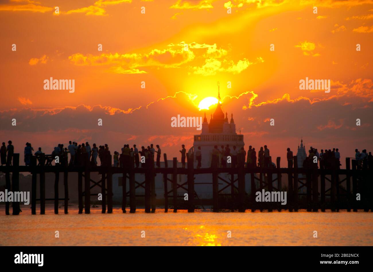 Burma / Myanmar: People gather to watch the sunset on the U Bein Bridge ...