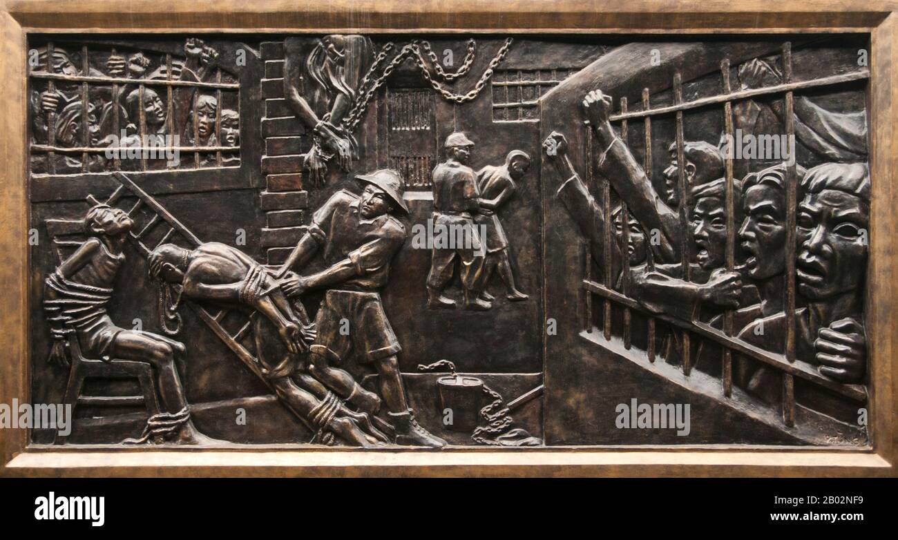 Vietnam: Bas-relief showing torture and brutality by the French colonialists within the prison, Hoa Lo Prison Museum (the old French Maison Centrale), Hanoi. The French colonial administration built Hoa Lo Prison in 1896. Originally intended to hold 450 prisoners, by the 1930s the number of detainees had soared to almost 2,000, the great majority political prisoners.  Hoa Lo Prison achieved notoriety during the Second Indochina War as a place of incarceration for downed US pilots, who ironically nicknamed the prison the ‘Hanoi Hilton’. Stock Photo
