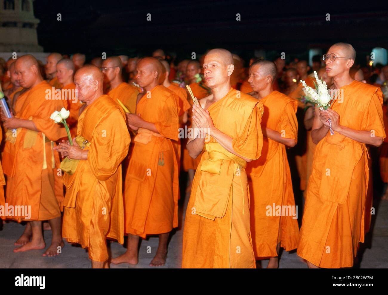 Beginning on the 15th day of the sixth lunar month, the Visakha Puja festival celebrates the Buddha’s birth, enlightenment and passing away, and is marked at Buddhist temples by chanting and preaching, and candlelit processions in the evening.  Wat Suthat Thepphawararam is a royal temple of the first grade, one of six such temples in Thailand. Construction was begun by King Buddha Yodfa Chulaloke (Rama I) in 1807. Further construction and decorations were carried out by King Buddha Loetla Nabhalai (Rama II) who helped carve the wooden doors, but the temple was not completed until the reign of Stock Photo