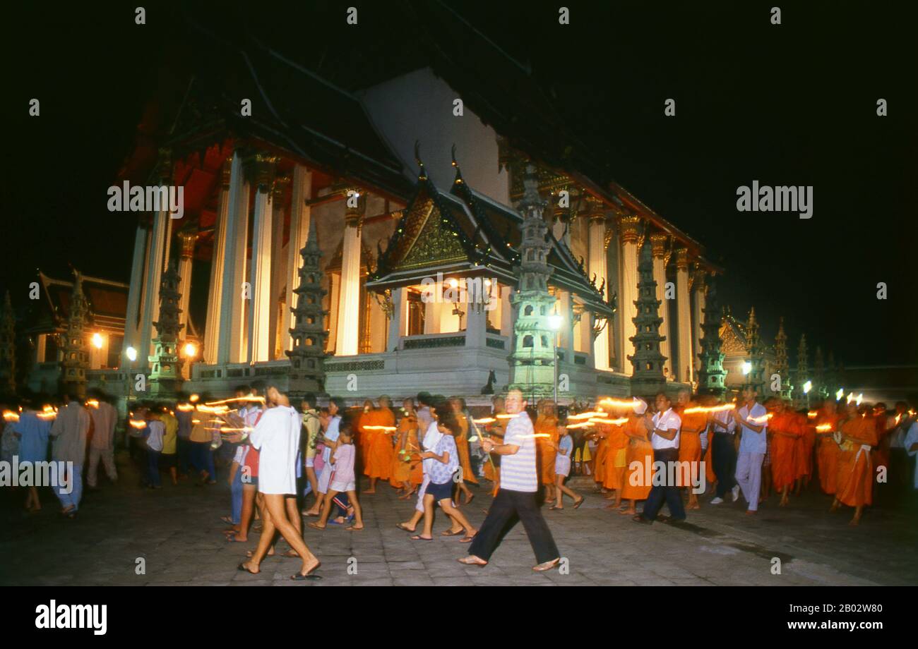 Beginning on the 15th day of the sixth lunar month, the Visakha Puja festival celebrates the Buddha’s birth, enlightenment and passing away, and is marked at Buddhist temples by chanting and preaching, and candlelit processions in the evening.  Wat Suthat Thepphawararam is a royal temple of the first grade, one of six such temples in Thailand. Construction was begun by King Buddha Yodfa Chulaloke (Rama I) in 1807. Further construction and decorations were carried out by King Buddha Loetla Nabhalai (Rama II) who helped carve the wooden doors, but the temple was not completed until the reign of Stock Photo