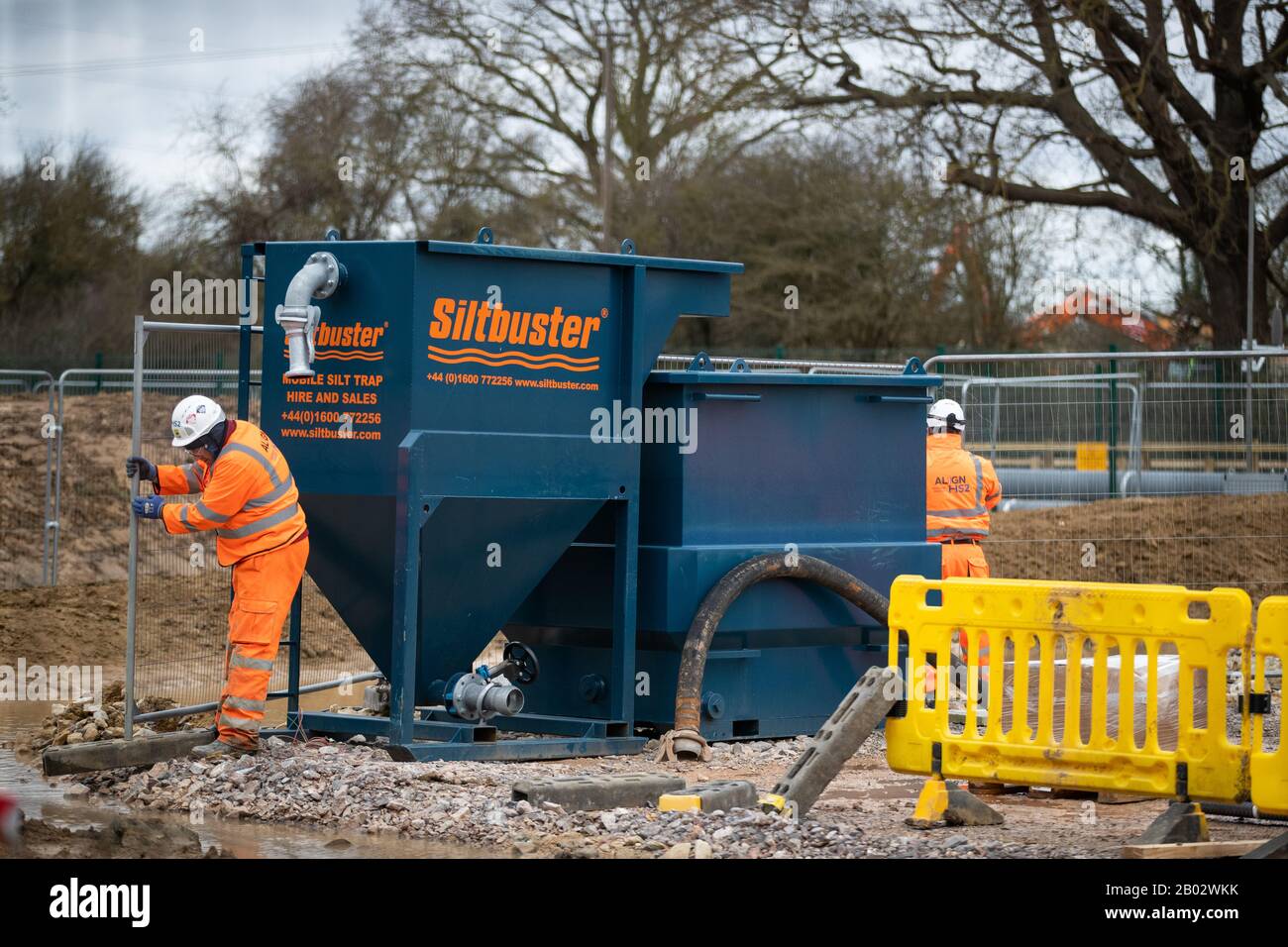 Workmen near the site where protestors have occupied a drilling platform used to drill the aquifer in Uxbridge, London. Stock Photo