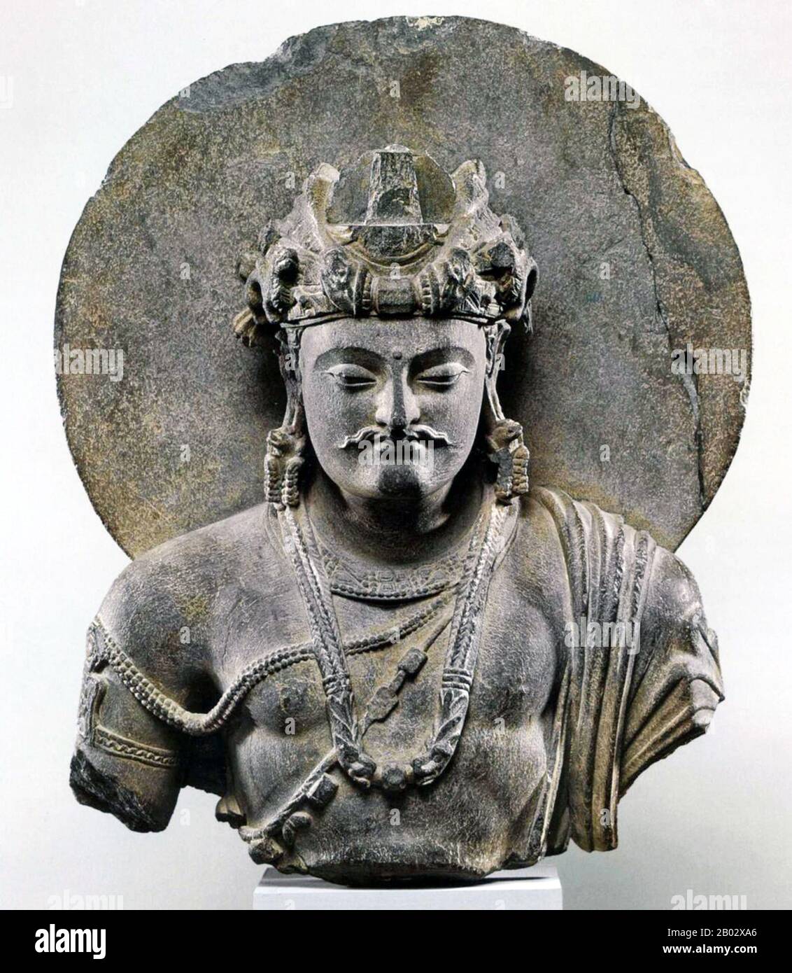 Gandhāra is noted for the distinctive Gandhāra style of Buddhist art, which developed out of a merger of Greek, Syrian, Persian, and Indian artistic influence. This development began during the Parthian Period (50 BCE – 75 CE). Gandhāran style flourished and achieved its peak during the Kushan period, from the 1st to the 5th century. It declined and suffered destruction after invasion of the White Huns in the 5th century.  Stucco as well as stone was widely used by sculptors in Gandhara for the decoration of monastic and cult buildings. Stucco provided the artist with a medium of great plastic Stock Photo