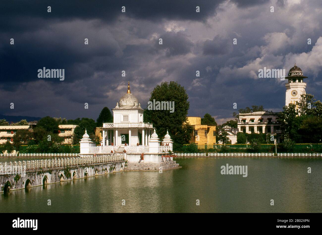 Rani Pokhari (Queen’s Pond), located off the northern end of the Tundikhel, is one of Kathmandu’s more attractive landmarks. The pond was dug between 1665 and 1670 by King Pratapa Malla to comfort his wife Bhavan Lakshmi over the death of their son Chakrabatindra Malla who had been trampled to death by an elephant.  In later years, the pond was used for trial by ordeal, in which the representatives of two conflicting parties had to submerge themselves in the water, the one with the greater lung capacity winning the case. With the beginning of Rana rule the ordeals were discontinued. Stock Photo