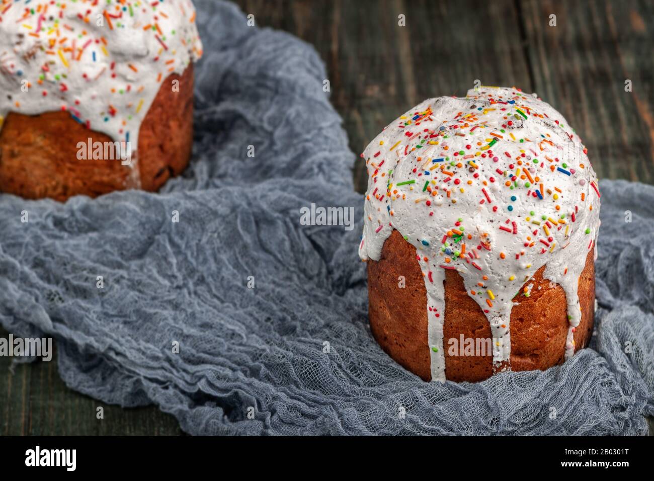 Freshly baked Easter cakes stand on a black wooden table Stock Photo