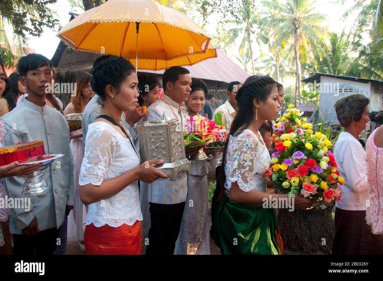 The traditional Khmer wedding is a long and colorful affair. Formerly it lasted three days, but since the 1980s it has more commonly lasted a day and a half.  The ceremony begins in the morning at the home of the bride and is directed by the achar (a specialist in ritual who acts as a master of ceremonies). Buddhist priests offer a short sermon and recite prayers of blessing. Parts of the ceremony involve ritual hair cutting and tying cotton threads soaked in holy water around the couple's wrists. Stock Photo