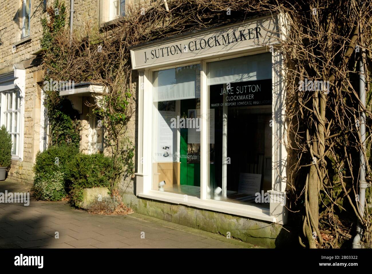 Fairford is a small Gloucestershire town.  Set in the Central Cotswolds it is a few miles East of Cirencester  J sutton Clockmaker shop Stock Photo