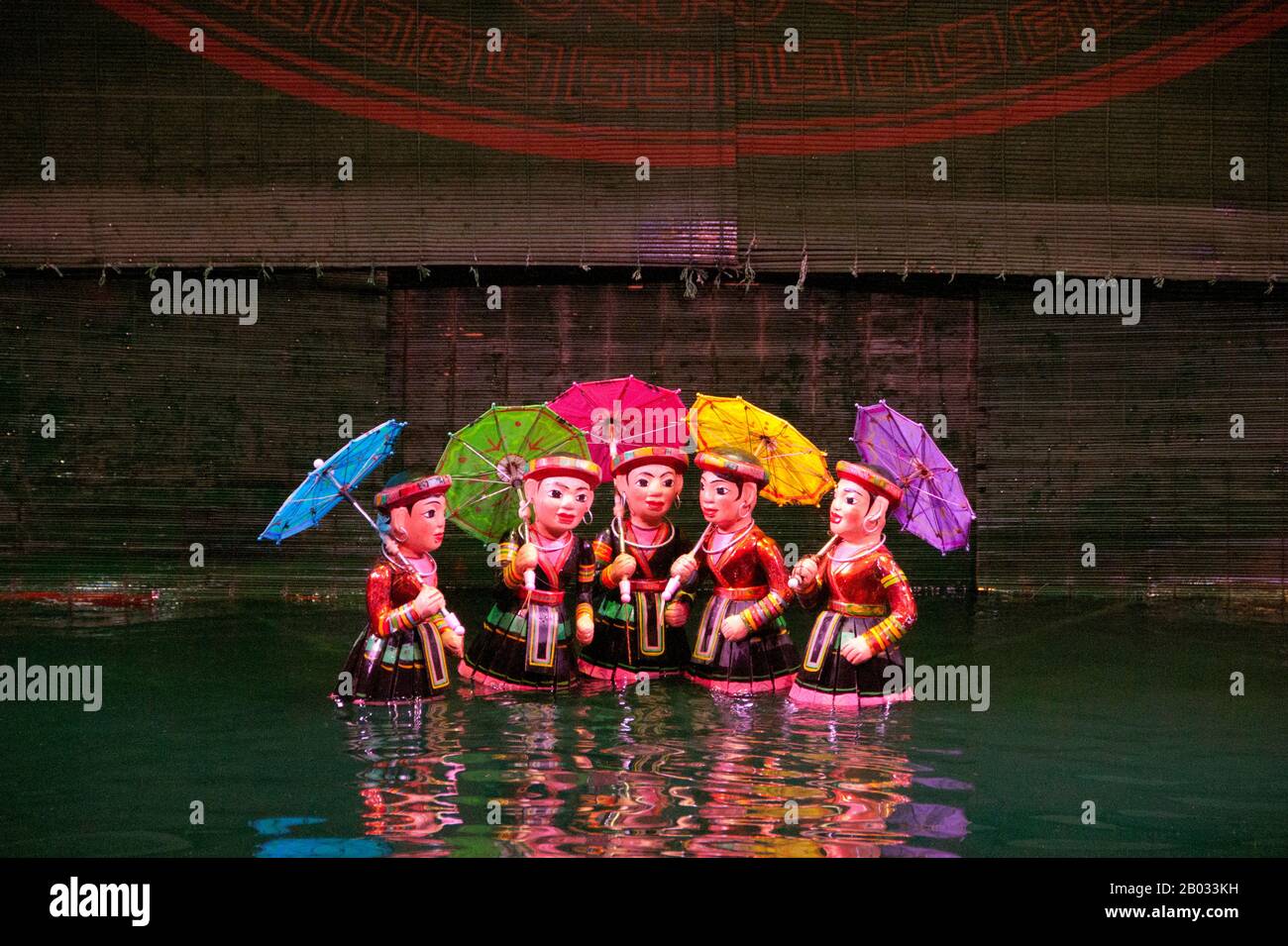 Water Puppetry or Múa rối nước, literally 'puppets that dance on water' originated in the Red River Delta. The puppets are carved from water-resistant wood to represent traditional rural lifestyles and mythical creatures. Standing behind the watery stage, waist-deep in water, the hidden puppeteers skillfully manoeuvre their wooden charges to the music of a traditional orchestra. Stock Photo