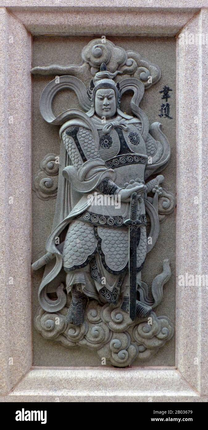 Malaysia / China: Carving of Wei Hu (Skanda), depicting his role in the 16th Century Ming Dynasty novel Fengshen Yanyi ('Investiture of the Gods'). From Ping Sien Si Temple, Pasir Panjang Laut. Photo by Anandajoti (CC BY 2.0). Wei Hu is a character from the classic Ming Dynasty novel 'Fengshen Yanyi', and was an analogue of Skanda (Kartikeya), the Hindu god of war. He was a disciple of the Heavenly Master of Divine Virtue, and wielded a demon suppression club. Possessed of monstrous strength, Wei Hu was bloodthirsty and loved fighting. Stock Photo