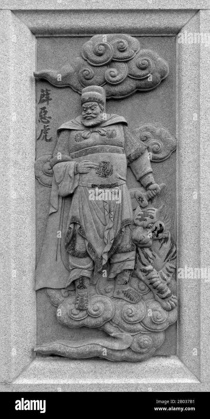China: Carving of Xue Ehu, depicting his role in the 16th Century Ming Dynasty novel Fengshen Yanyi ('Investiture of the Gods'). From Ping Sien Si Temple, Pasir Panjang Laut. Photo by Anandajoti (CC BY 2.0). Xue Ehu was a character from the classic Ming Dynasty novel 'Fengshen Yanyi'. Xue Ehu, also known as Wicked Tiger, was a disciple of Heavenly Master of Divine Virtue, and aided the Zhou army by bringing them food when West Qi was under siege. He was eventually killed by Heavenly Master Yuan Jue. Stock Photo