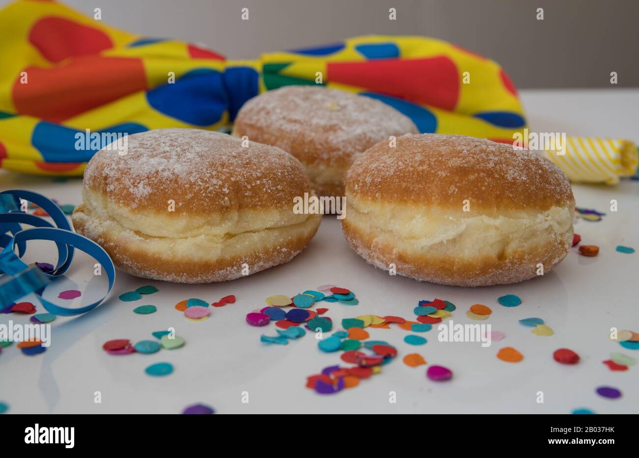 close-up of three donuts with carnival decoration around them Stock Photo