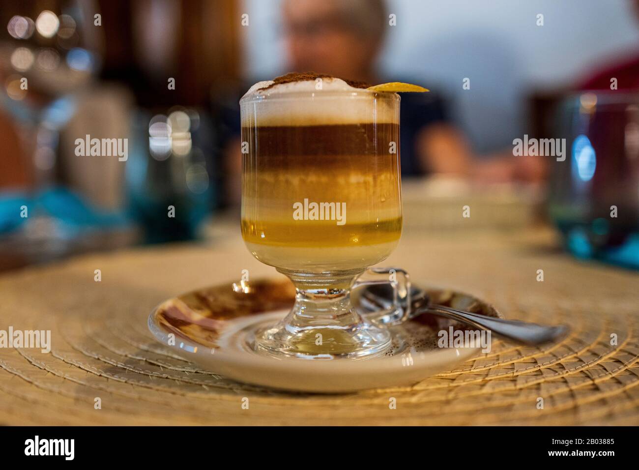 Speciality liqor coffee known as a barriquito, layers of condensed milk, oroang liquor, coffe, and frothy milk topped with cinnamon and lemon rind, Te Stock Photo