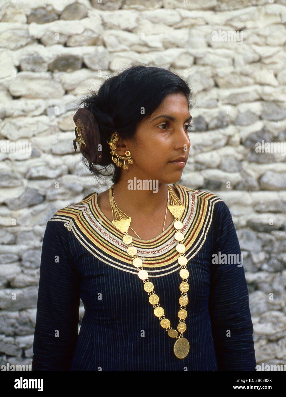 The dhivehi libaas is a traditional Maldivian dress for women. The neckline is adorned with what is called Kasabu viyun, a collar hand stitched with silver and gold laces.  On the eastern rim of the South Nilandhoo Atoll lies the tiny island of Rinbudhoo. Here, in one of the quietest and cleanest villages in the Maldives, lives the country's only group of hereditary goldsmiths. Melting down Victorian gold sovereigns and Marie-Therèse thalers as casually as recently-imported mini-ingots from Dubai, they manufacture an exquisite range of chains, necklaces, ear-rings, finger-rings and amulets.  A Stock Photo