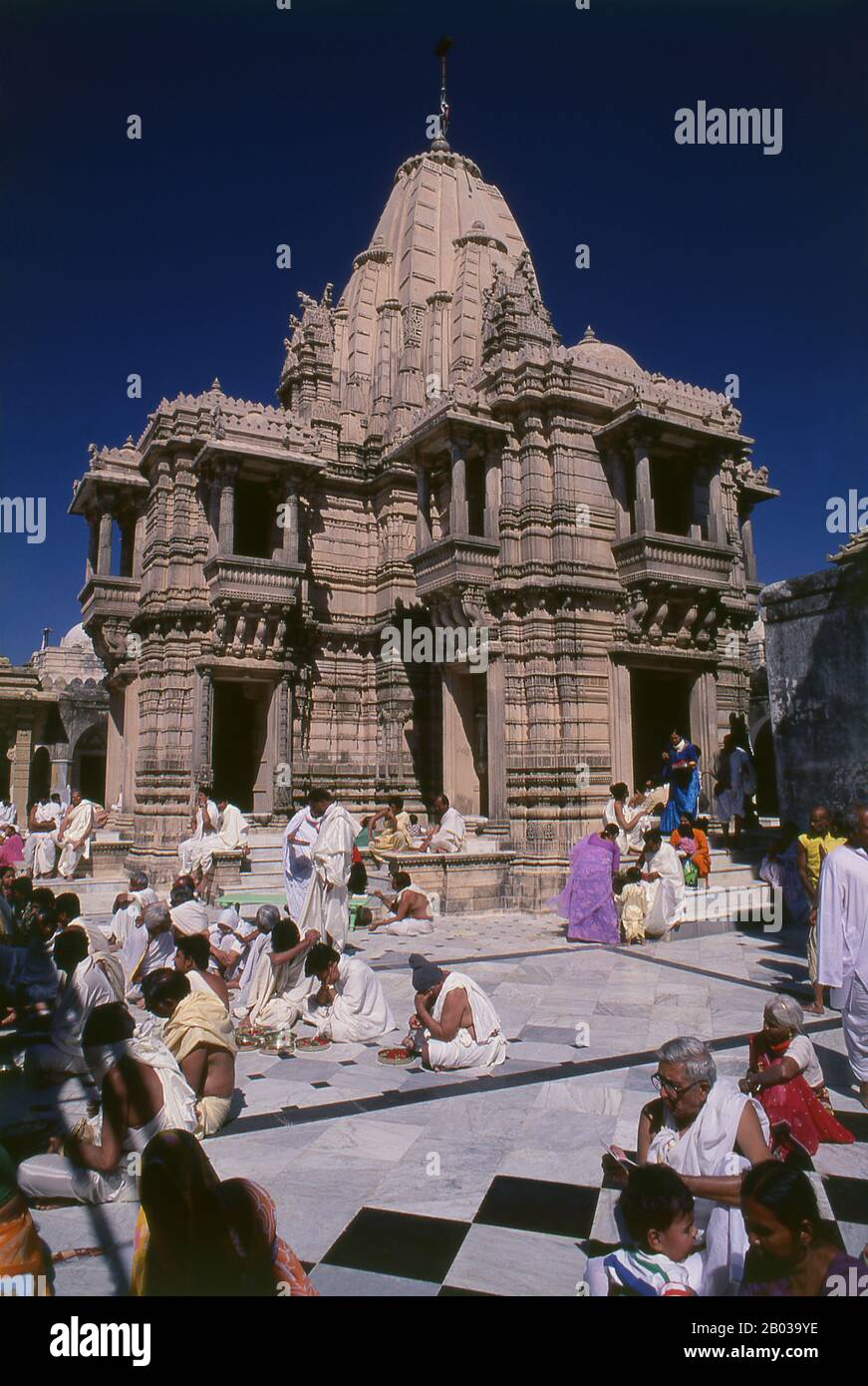 The Jain's sacred site of Shatrunjaya contains hundreds of Palitana temples built mostly between the 11th Century and 16th Century CE. The Shatrunjaya Hills were sanctified when Rishabha, the first tirthankara (omniscient Teaching God) of Jainism, gave his first sermon in the temple on the hill top. The ancient history of the hills is also traced to Pundarika Swami, a chief Ganadhara and grandson of Rishabha, who attained salvation here. His shrine located opposite to the main Adinath temple, built by his son Bharata, is also worshiped by pilgrims. Stock Photo