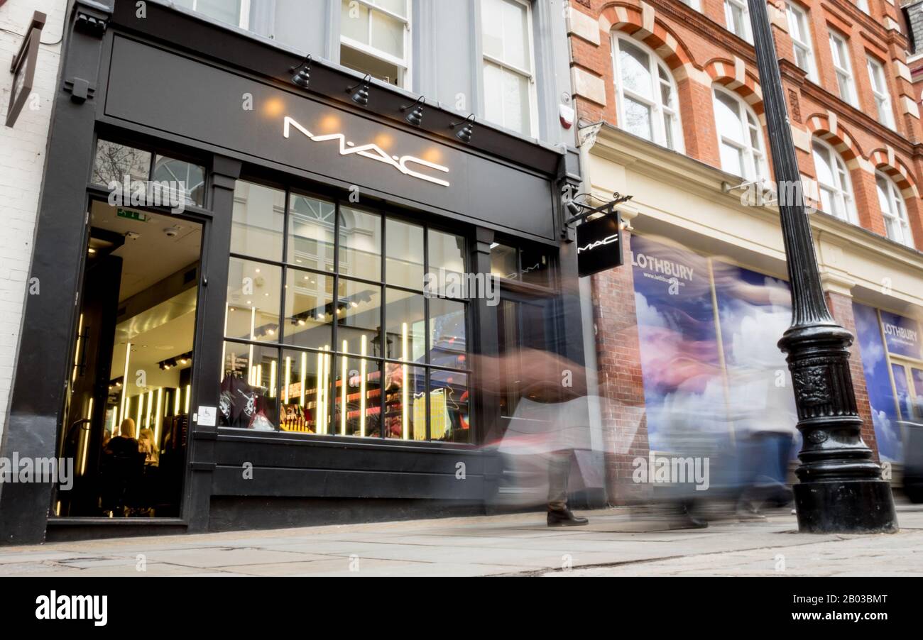 Mac store, Covent Garden, London. Long exposure, blurred shoppers walking by the shop front to the high street cosmetics store, Mac. Stock Photo