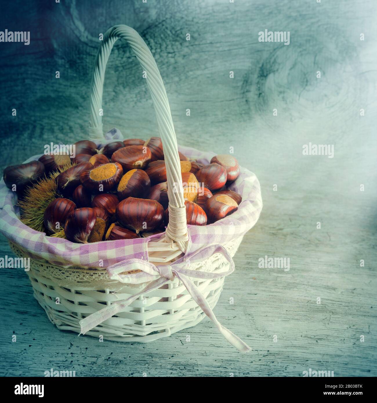 wicker basket with freshly picked chestnuts Stock Photo