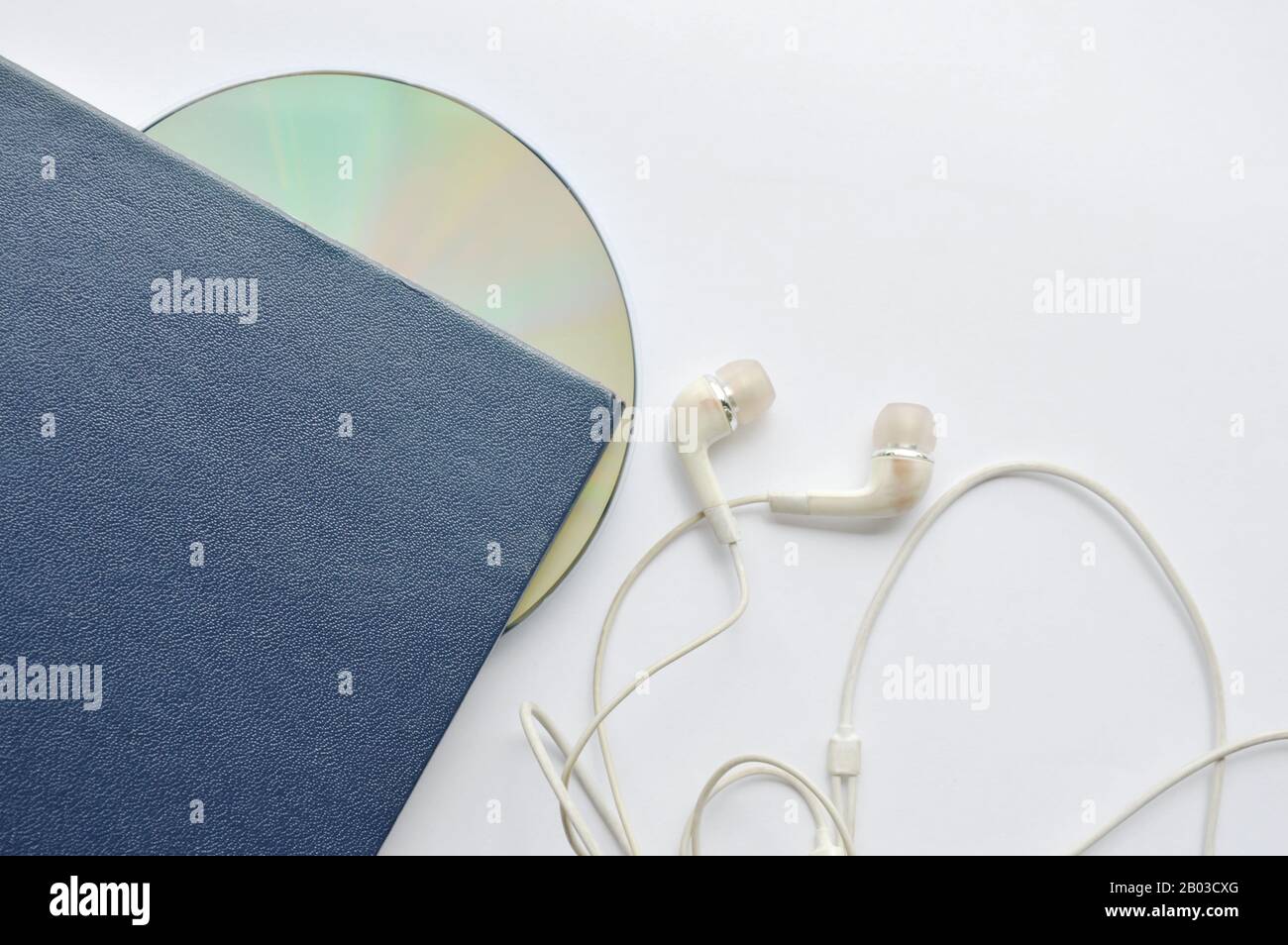 book and CD- rom with earphones on white background Stock Photo
