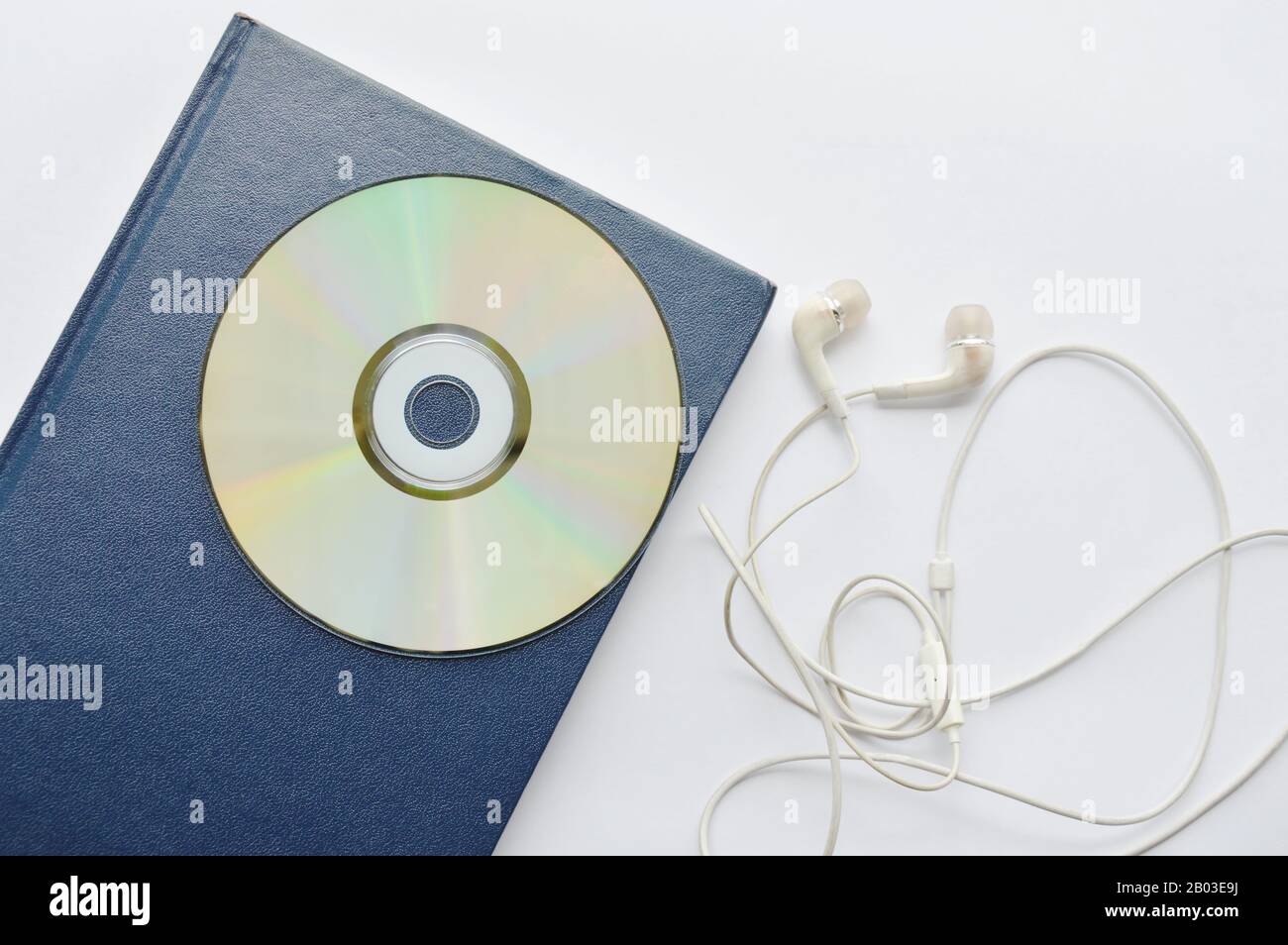book and CD- rom with earphones on white background Stock Photo