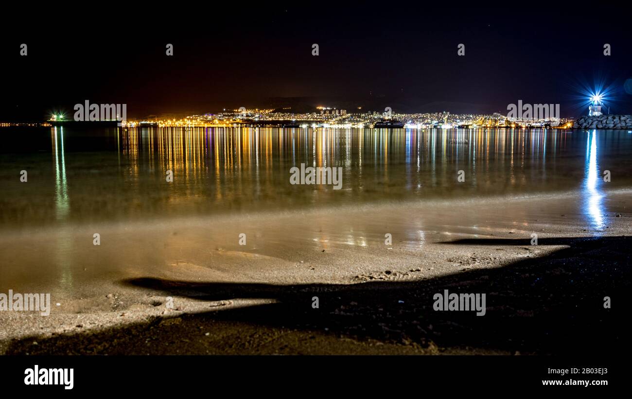 Jordan, Israel and Egypt. Long exposure at coast of Gulf of Aqaba on Red Sea, winter night. Travel to Middle East, kingdom of Jordan. Three countries presented in single photograph, water reflections Stock Photo