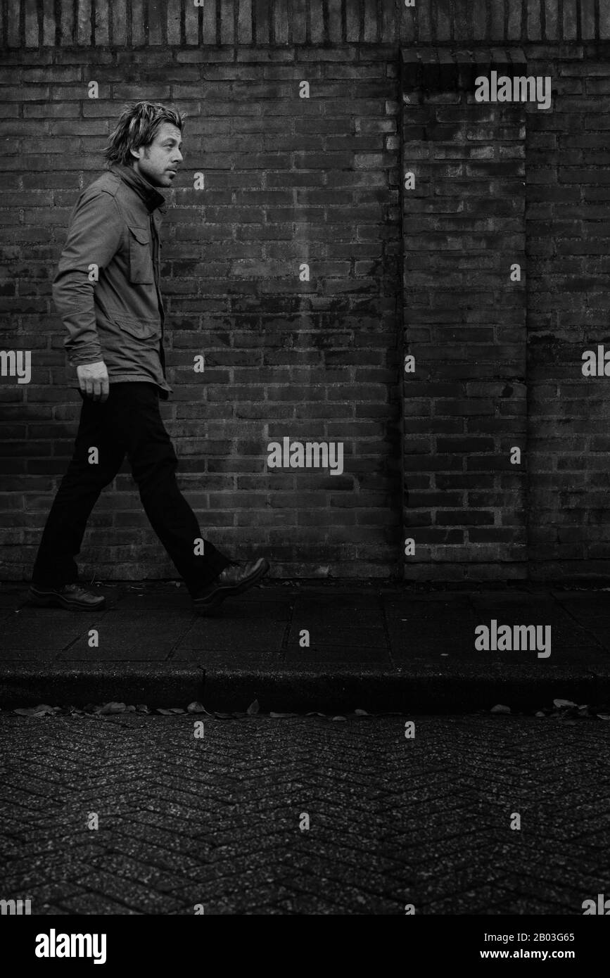Man walking side view jacket Black and White Stock Photos & Images - Alamy