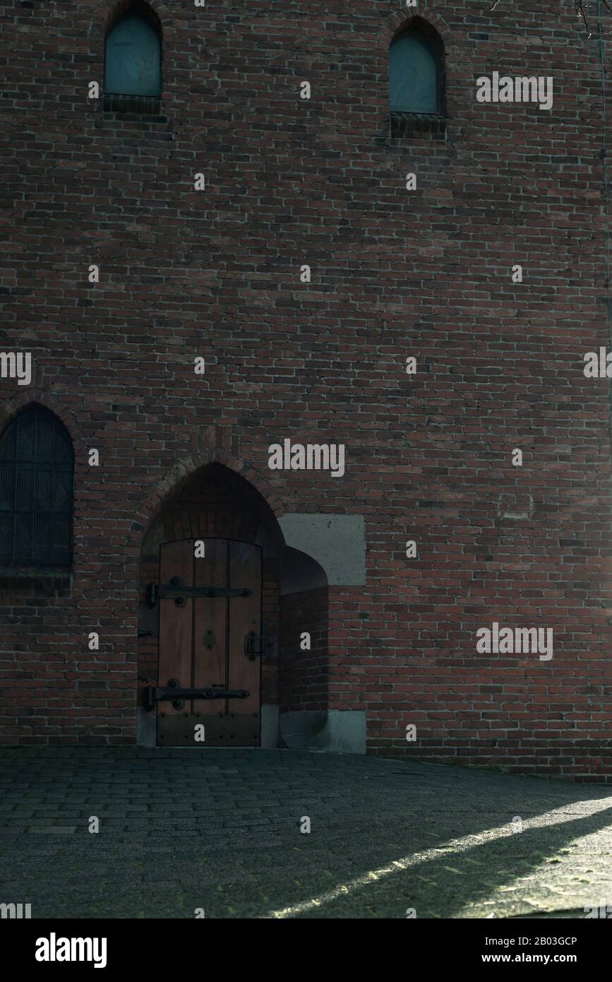 Brick wall of church with window and wooden door Stock Photo - Alamy