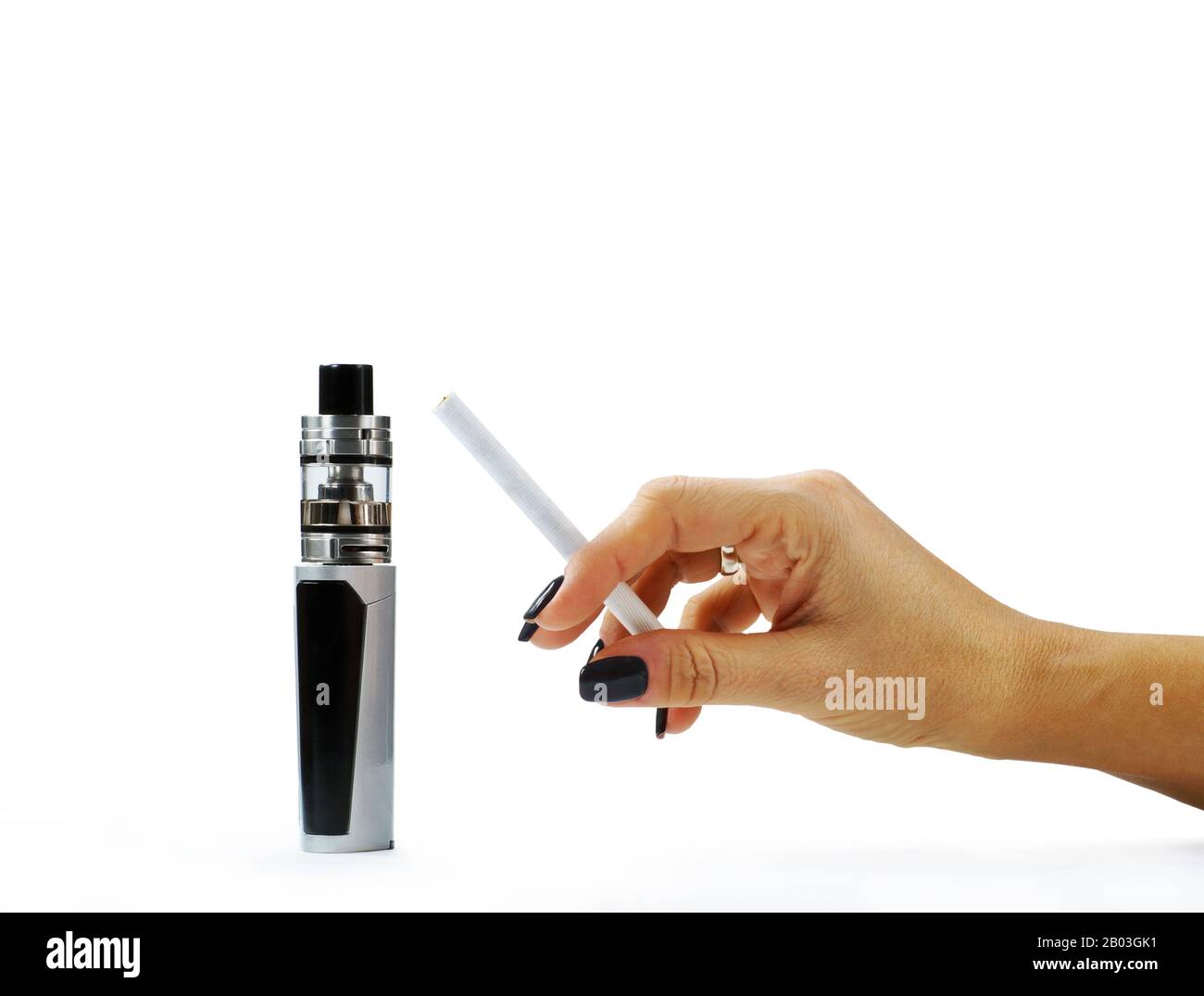 A woman's hand holding a cigarette next to a standing ecigarette