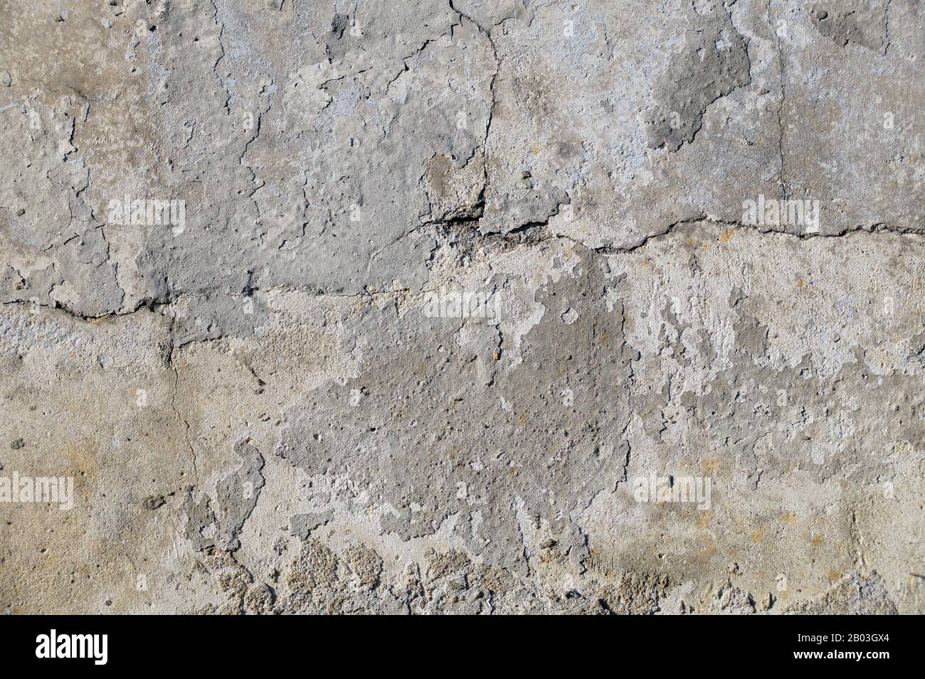 Old, cracked wall surface. Close-up on a plastered wall. Stock Photo