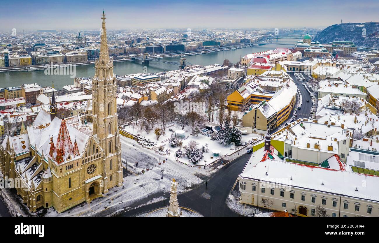 Budapest, Hungary - Aerial panoramic view of the snowy Buda district with Matthias Church, Buda Castle Royal Palace, Szechenyi Chain Bridge and Statue Stock Photo