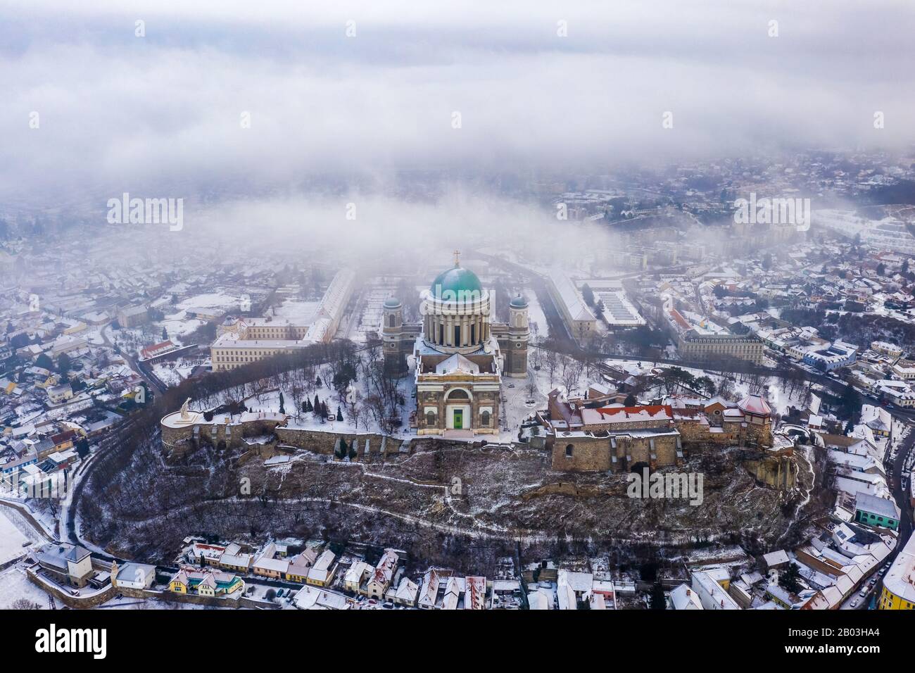 Esztergom, Hungary - Aerial view of the beautiful snowy Basilica of Esztergom on a foggy winter morning Stock Photo