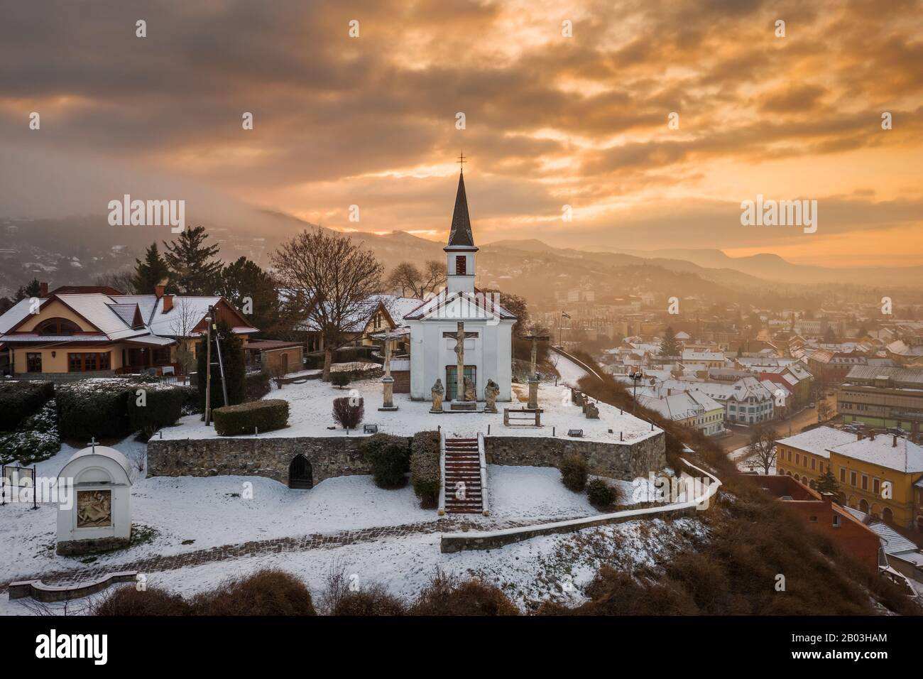 Esztergom, Hungary - Amazing golden sunrise at the Sorrowful Virgin Chapel on a misty winter morning Stock Photo