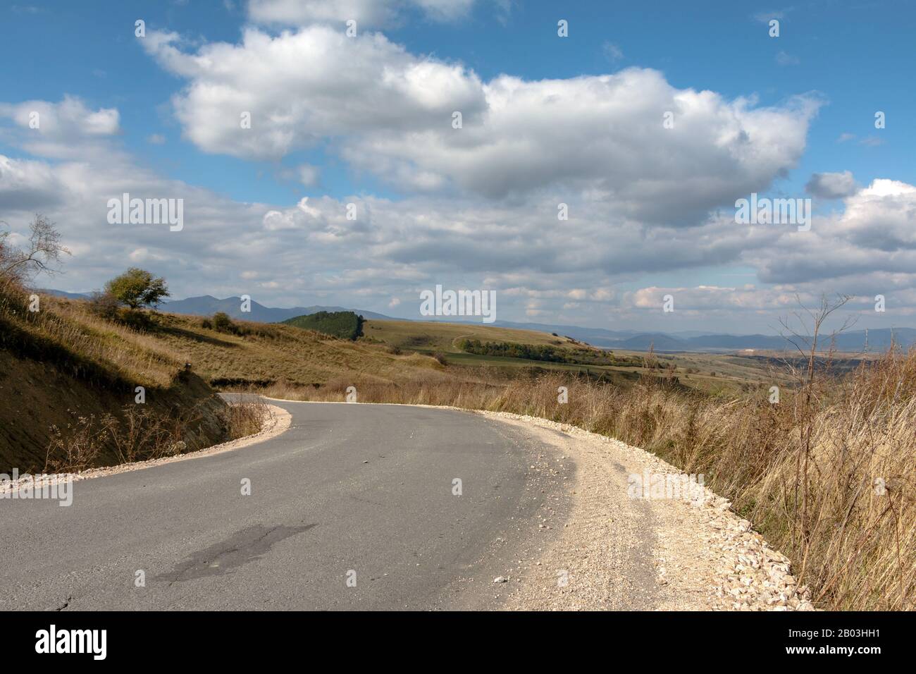 A country road in the rolling hills of the Kalotaszeg / Tara Calatei region of Transylvania Stock Photo