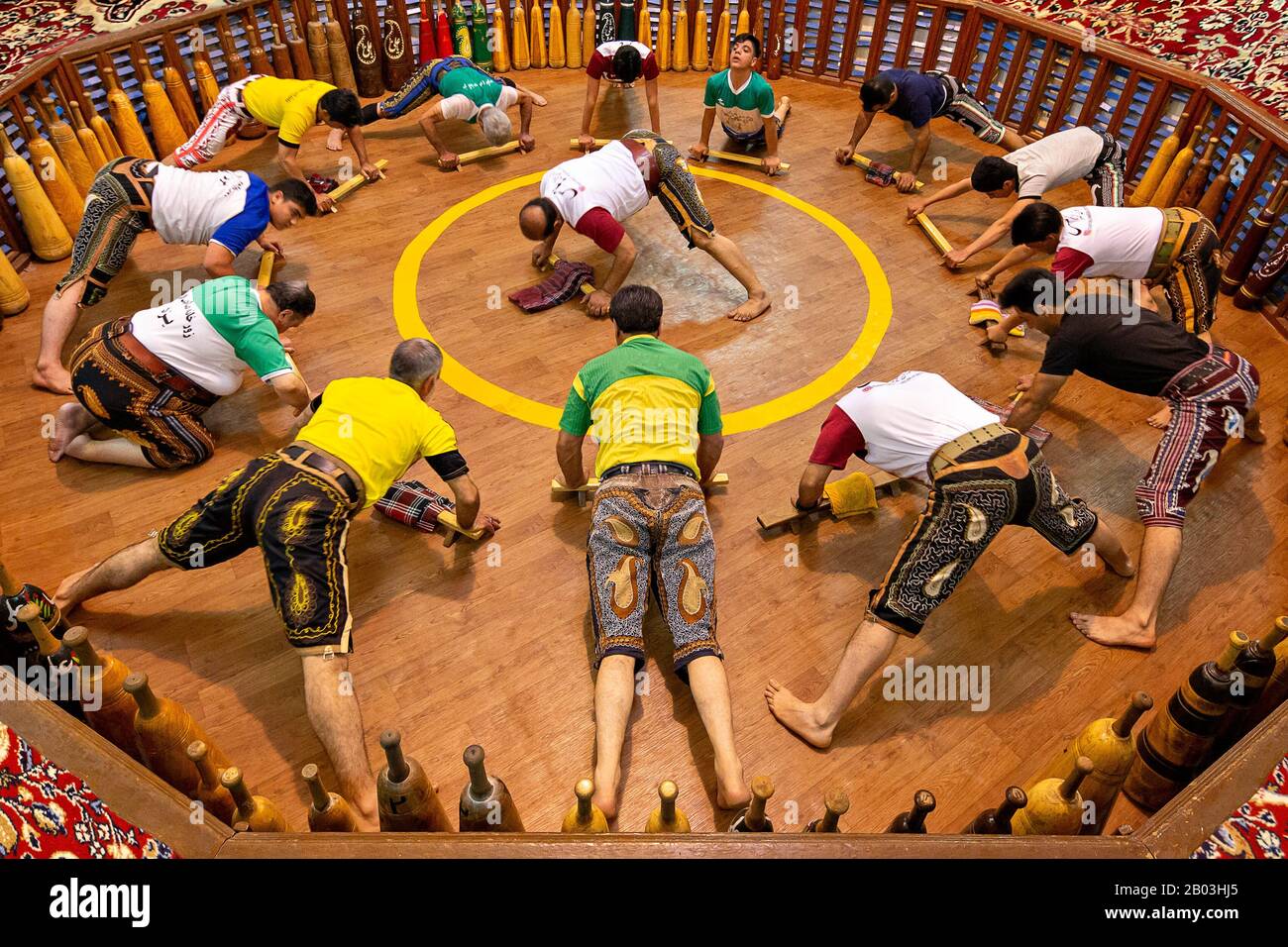 Men exercising traditional way, known as Zurkhaneh. It is a traditional Iranian system of athletics originally used to train warriors, Yazd, Iran Stock Photo