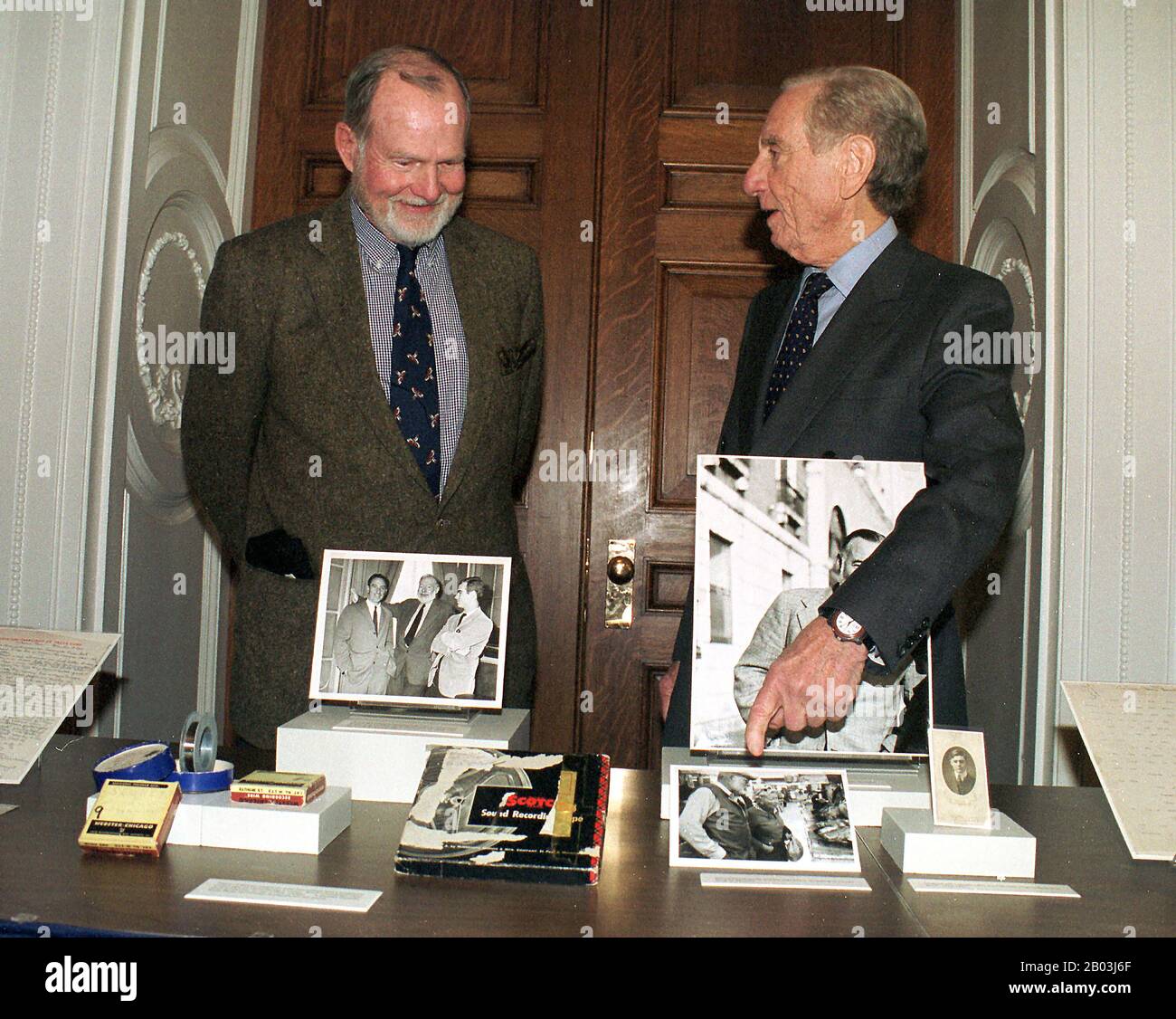 A.E. Hotchner, 79, right, a novelist and dramatist who adapted some of Ernest Hemingway's works for television, shows some his collection of Hemingway photos and recordings to the author's son, John Hemingway, left, as he donates them to the Library of Congress in Washington, DC on 27 October, 1999.  Currently, Hotchner and Paul Newman are partners in 'Newman's Own' food products, whose net profits are donated to charity. Credit: Ron Sachs / CNP | usage worldwide Stock Photo