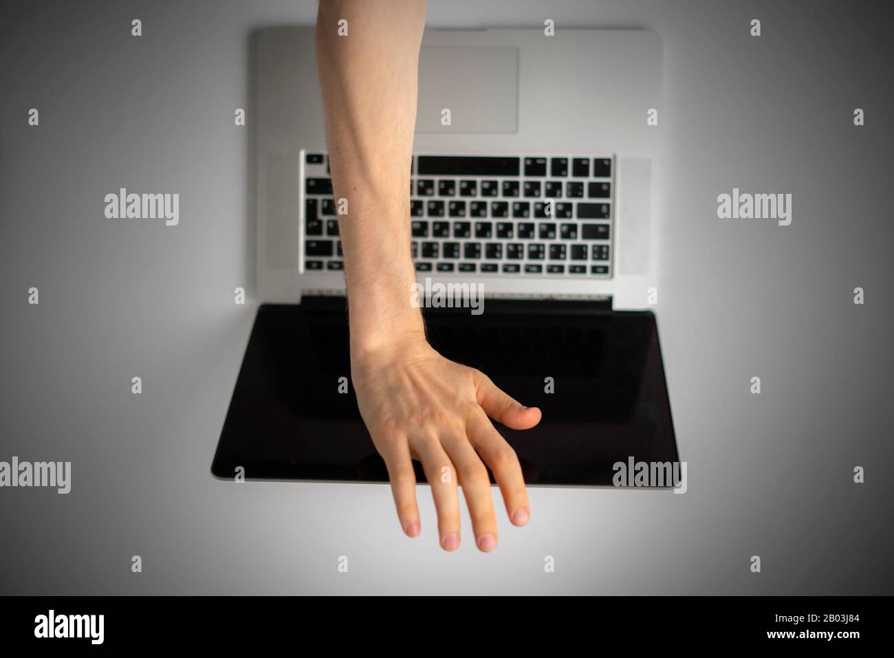a top view of person hands close cover or block the laptop webcam, being  afraid of spy hack the camera Stock Photo - Alamy