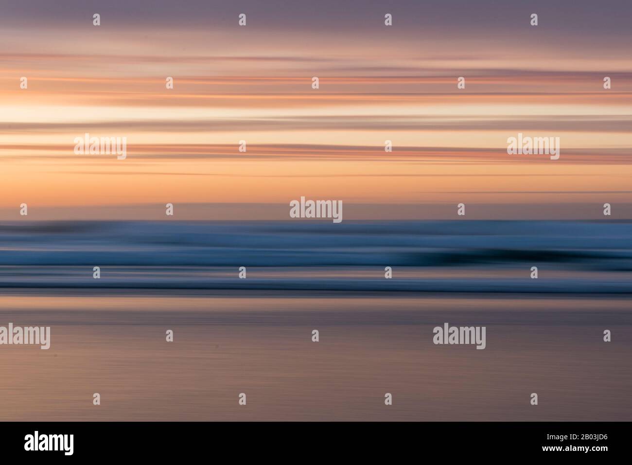 Intentional Camera Movement used to create a blurry layered look during a sunset at Godrevy Beach, Cornwall Stock Photo