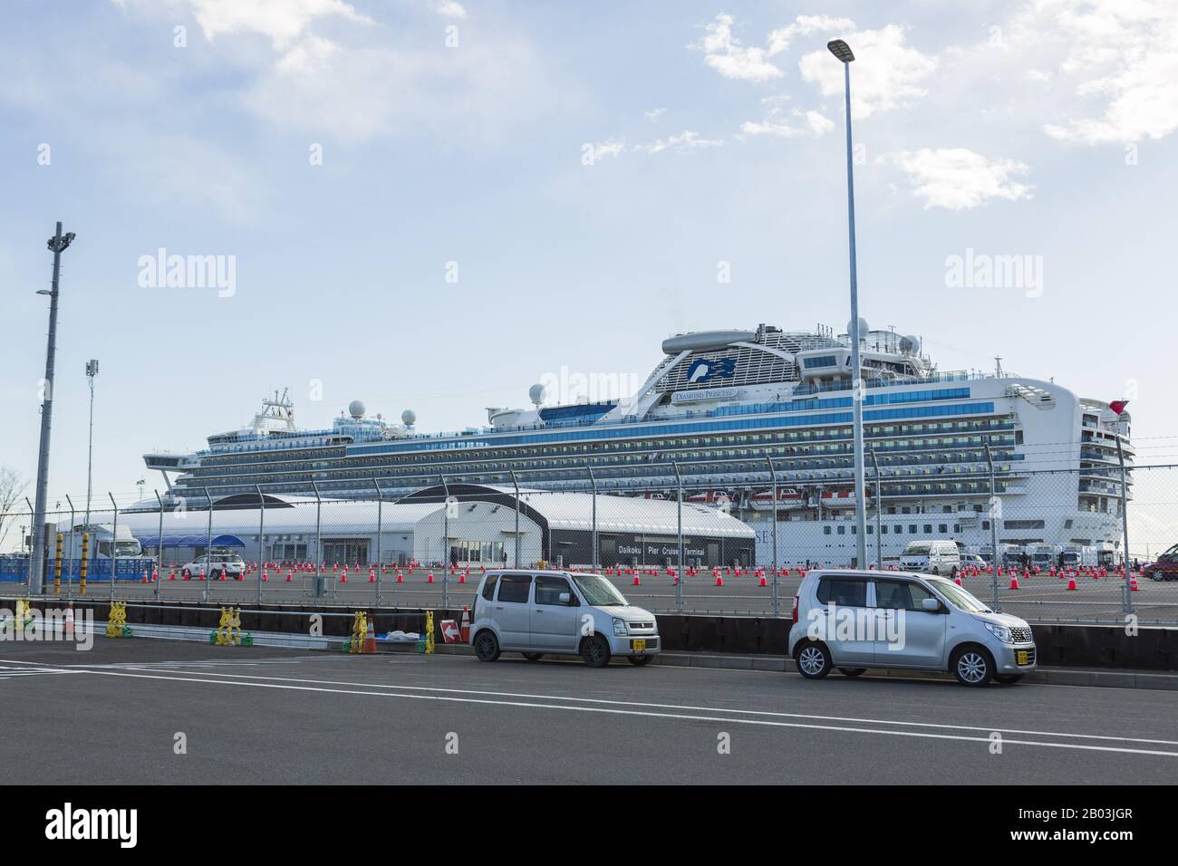 Yokohama, Japan. 18th Feb, 2020. The quarantined cruise ship Diamond Princess anchors at the Daikoku Pier Cruise Terminal in Yokohama, south of Tokyo. Japanese health minister Katsunobu Kato, said during a press conference on Tuesday, people on board who test negative for the new coronavirus would start disembarking from Wednesday. About 3200 passengers and crew are remained on a quarantined cruise, docked at Yokohama Port. Credit: Rodrigo Reyes Marin/ZUMA Wire/Alamy Live News Stock Photo